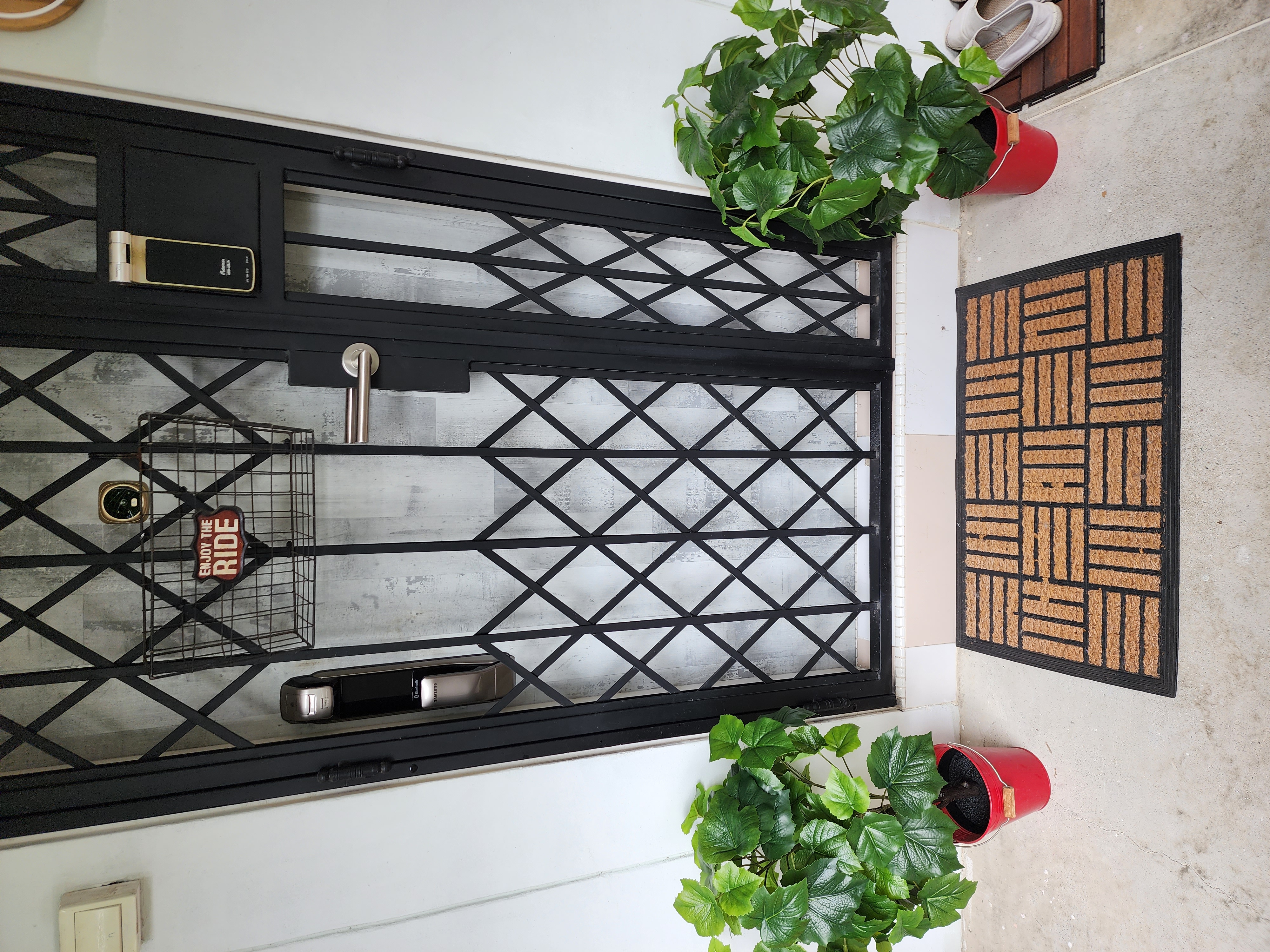 First Impression Matters - Entryway - black metal gate, modern entrance, stylish entryway, geometric design, black and white