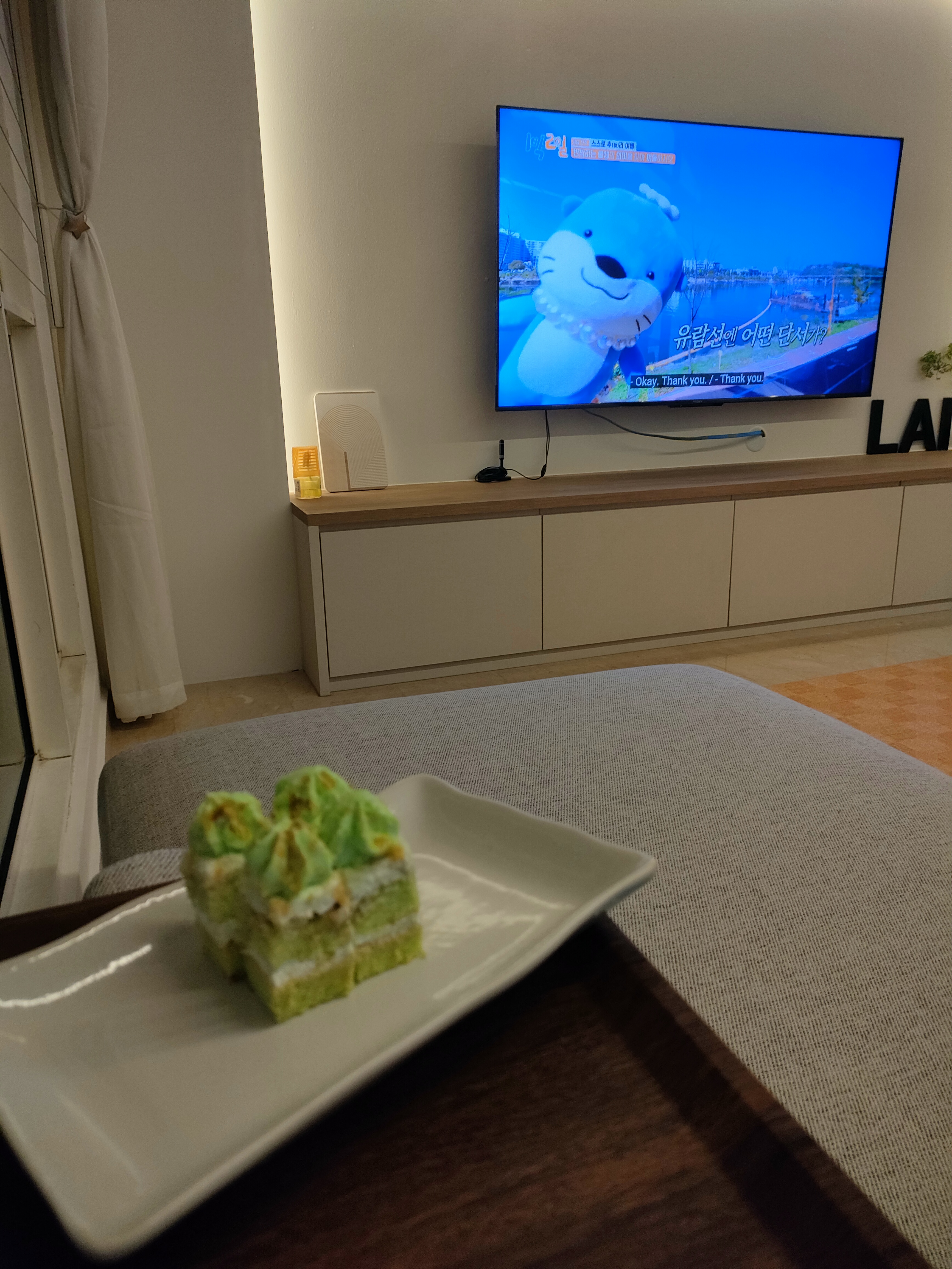 What makes the house our home... - Television, animated character, blue background, cozy room, soft lighting, modern decor