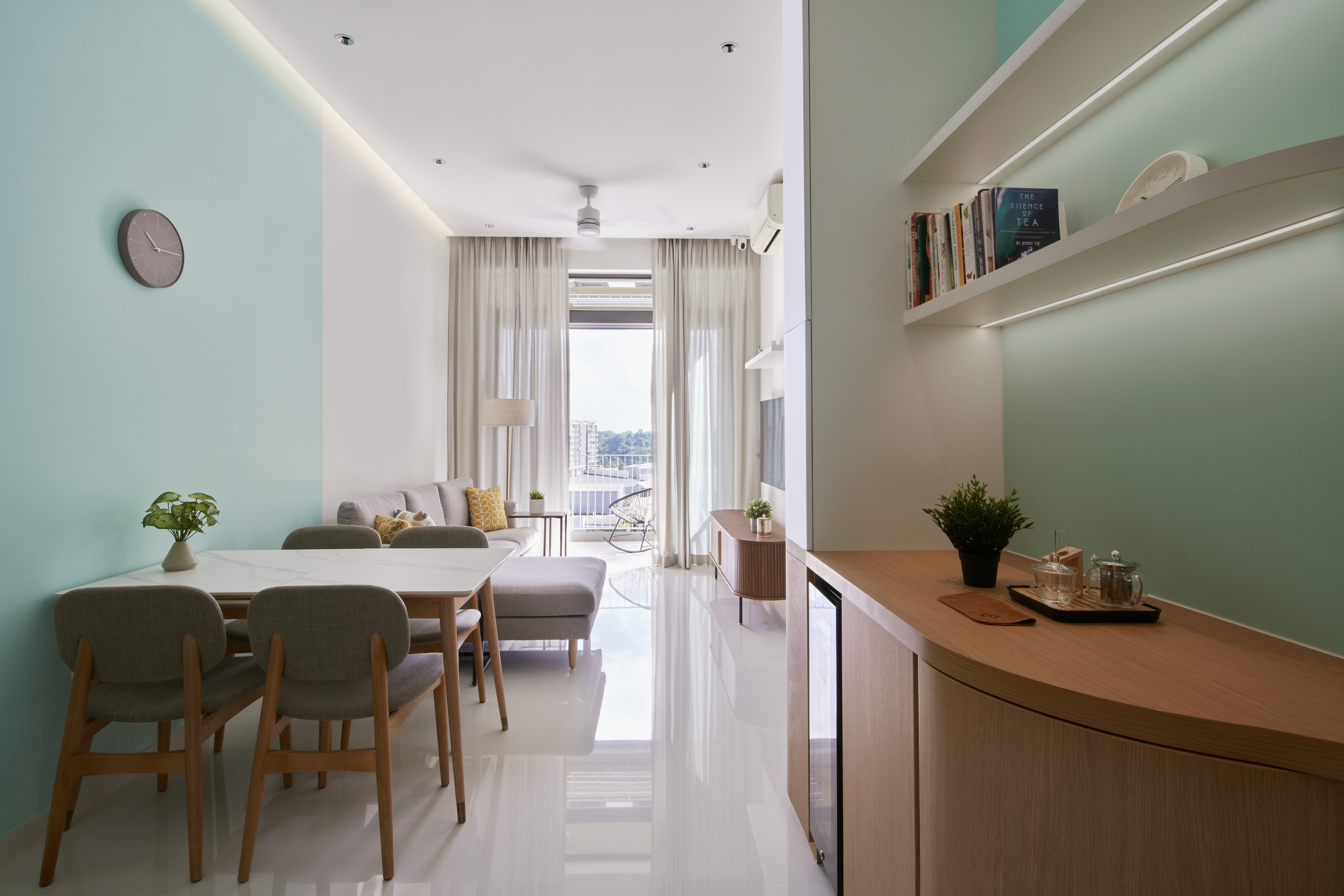 Crafting A Whimsical & Airy Home - Modern minimalist dining room, light blue walls, white ceiling, sleek ceiling light