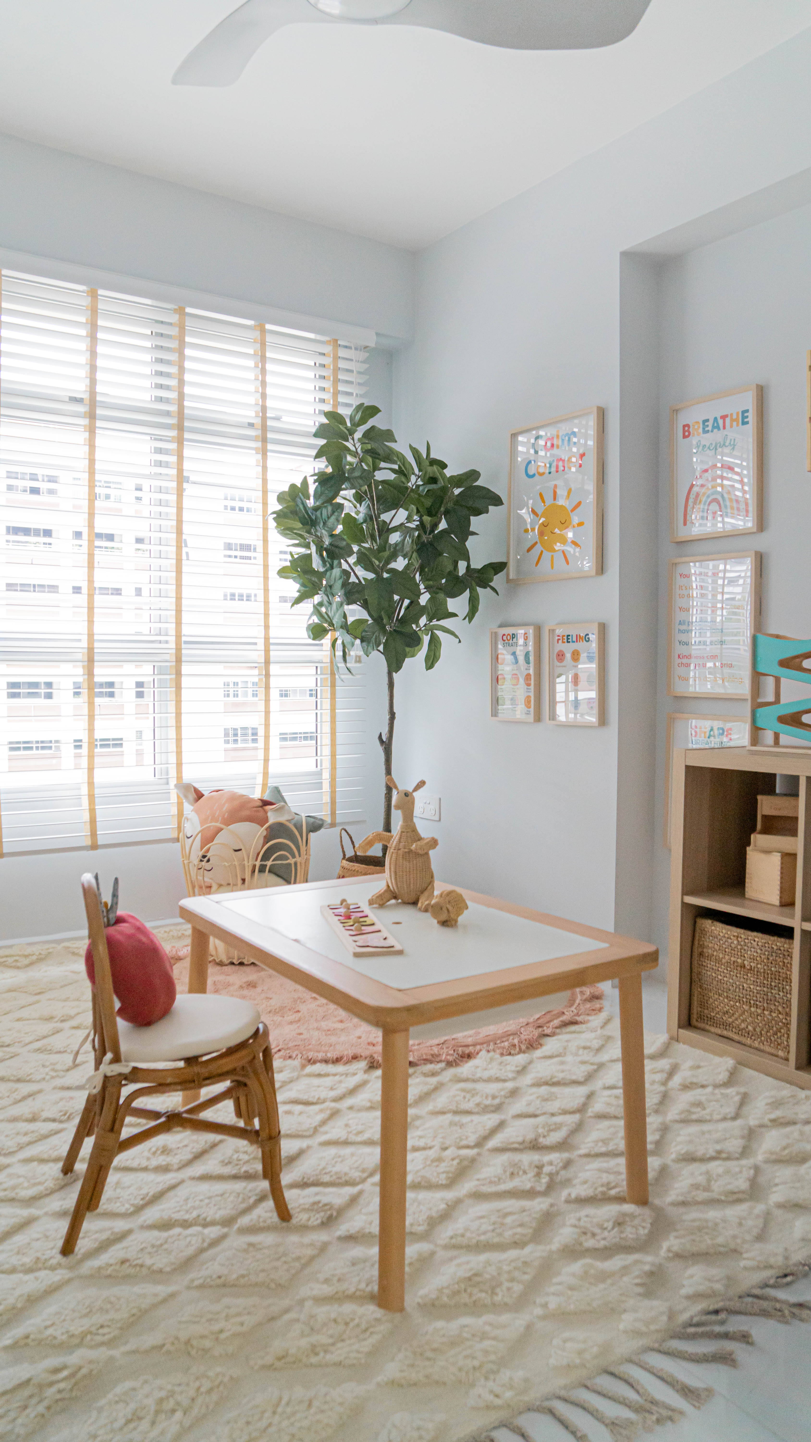 Gender Neutral Kids' Playroom + Girly Dress-Up Room - Light blue walls, white ceiling, large window with blinds, green plant