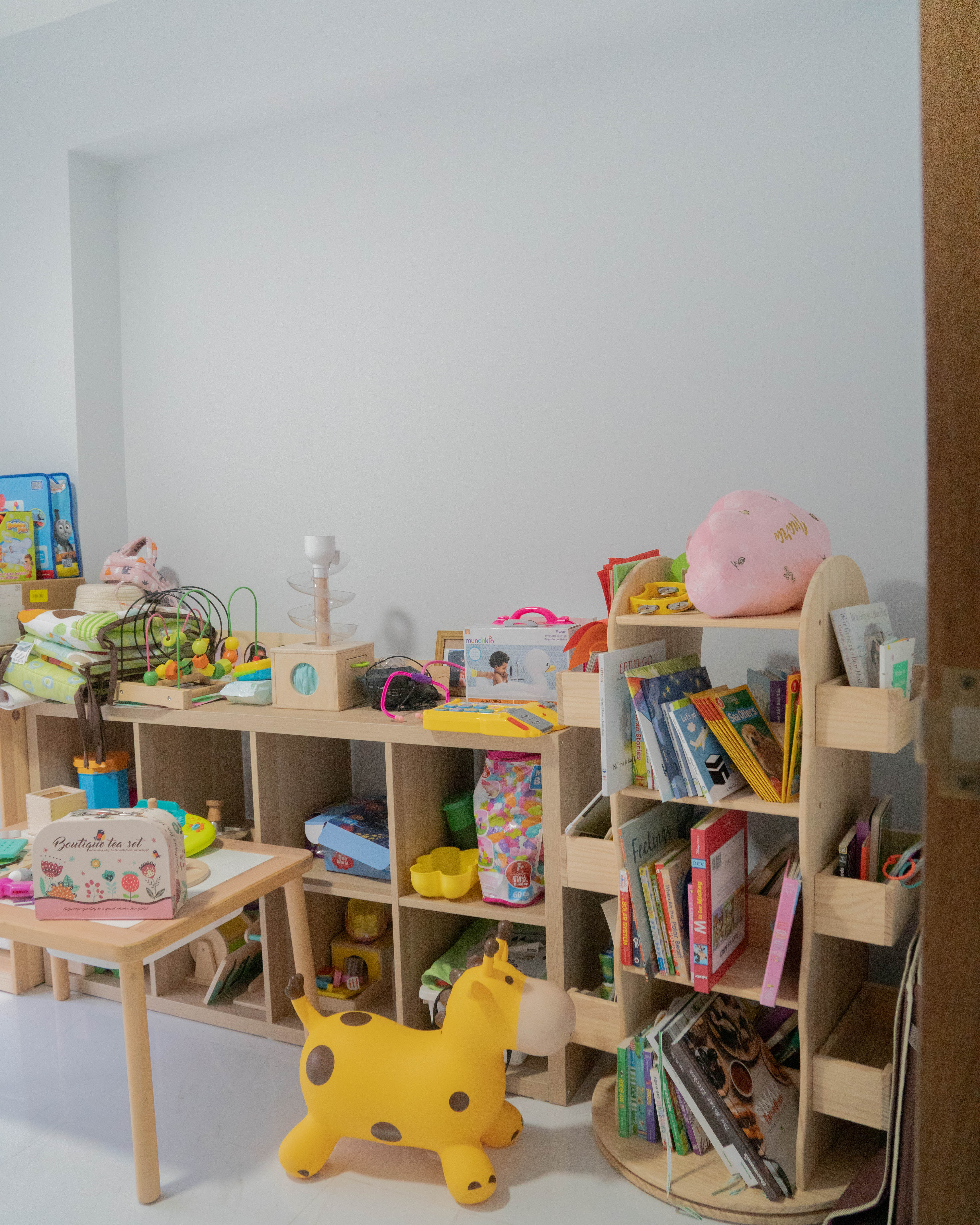Gender Neutral Kids' Playroom + Girly Dress-Up Room - Children's playroom, wooden shelves, colorful toys, educational books