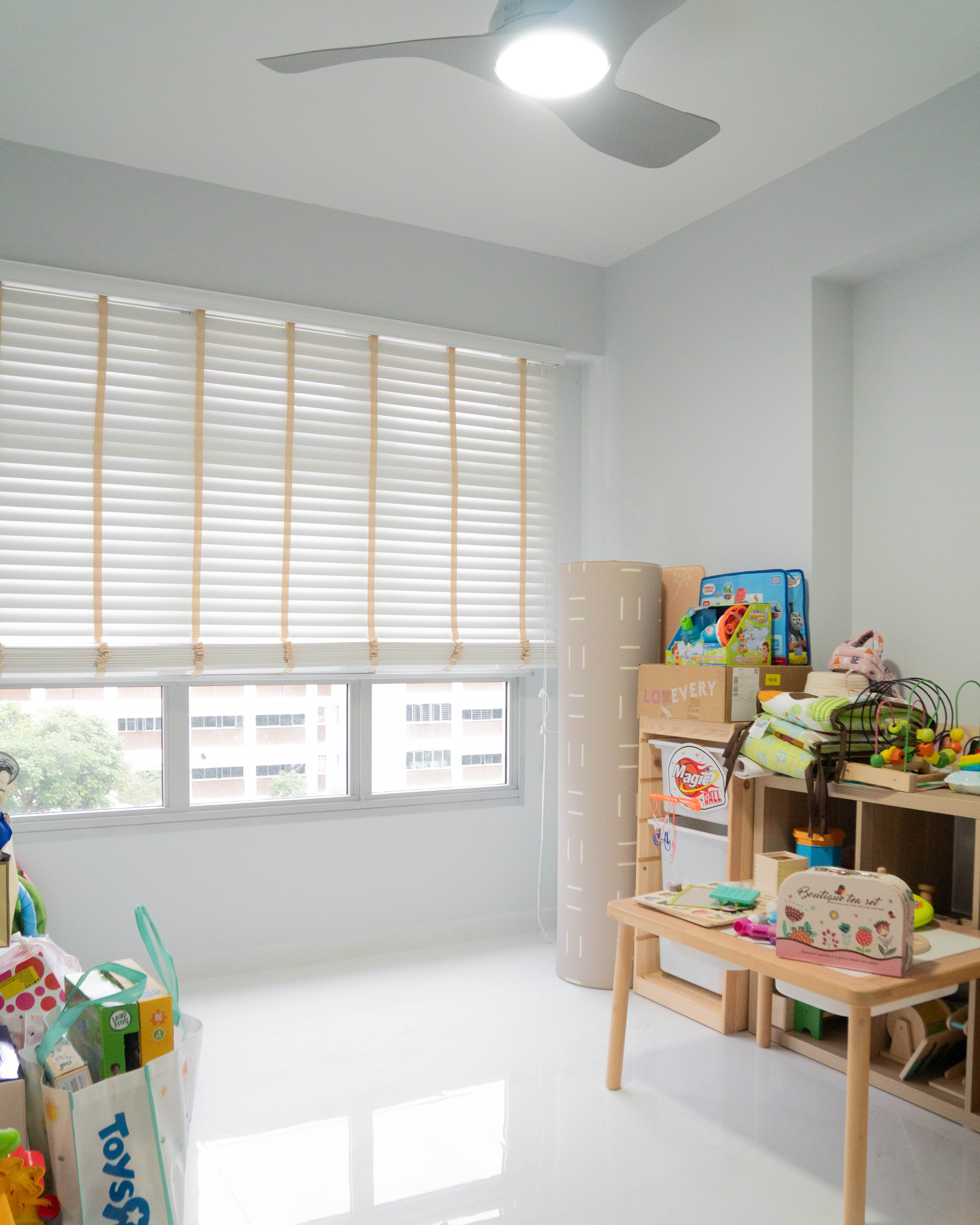 Gender Neutral Kids' Playroom + Girly Dress-Up Room - Bright room with large window, white blinds, ceiling fan, wooden
