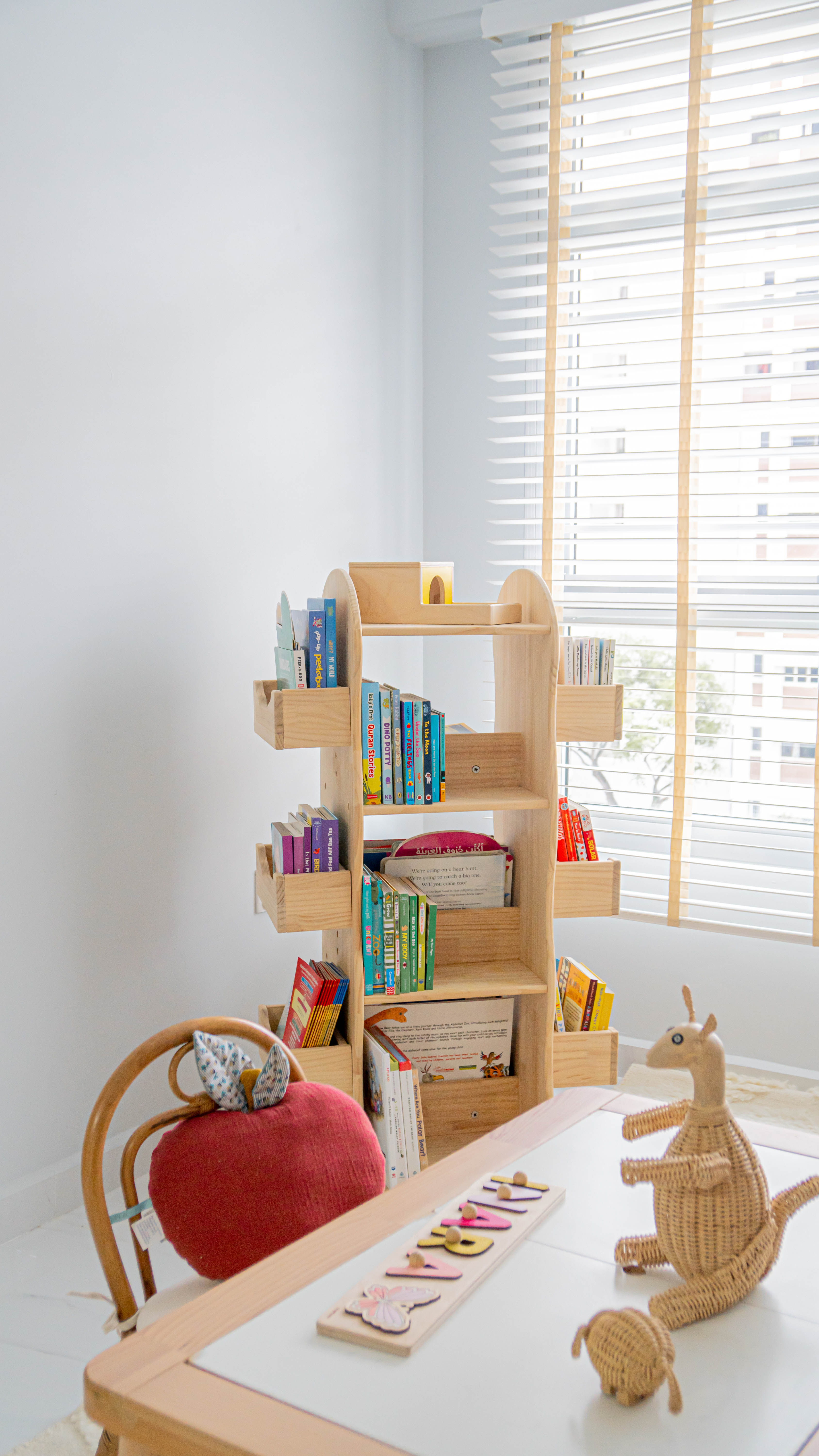 Gender Neutral Kids' Playroom + Girly Dress-Up Room - Wooden bookshelf, children's room, colorful books, wooden shelf