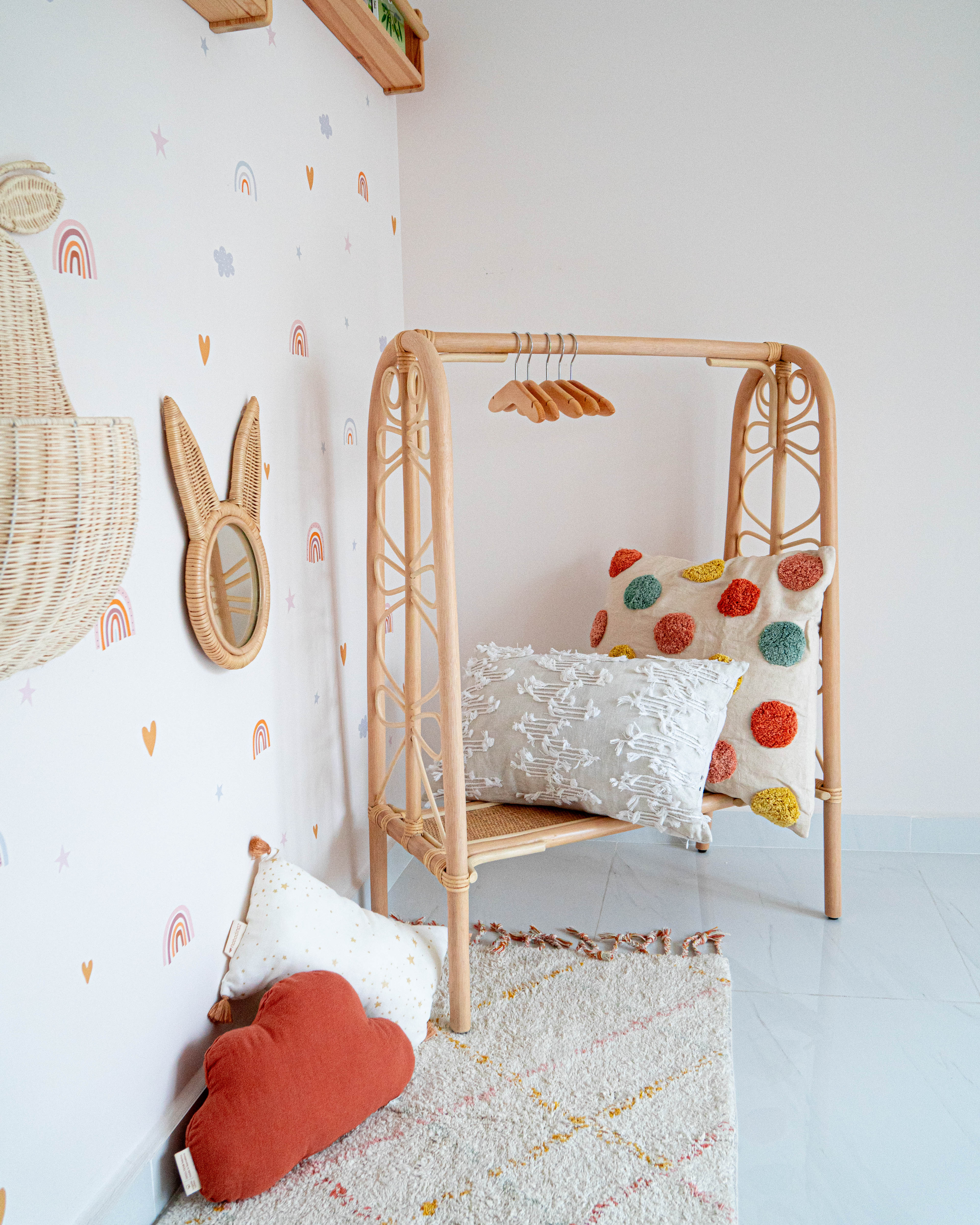 Gender Neutral Kids' Playroom + Girly Dress-Up Room - Wall with playful decorations, wooden crib with colorful pillows
