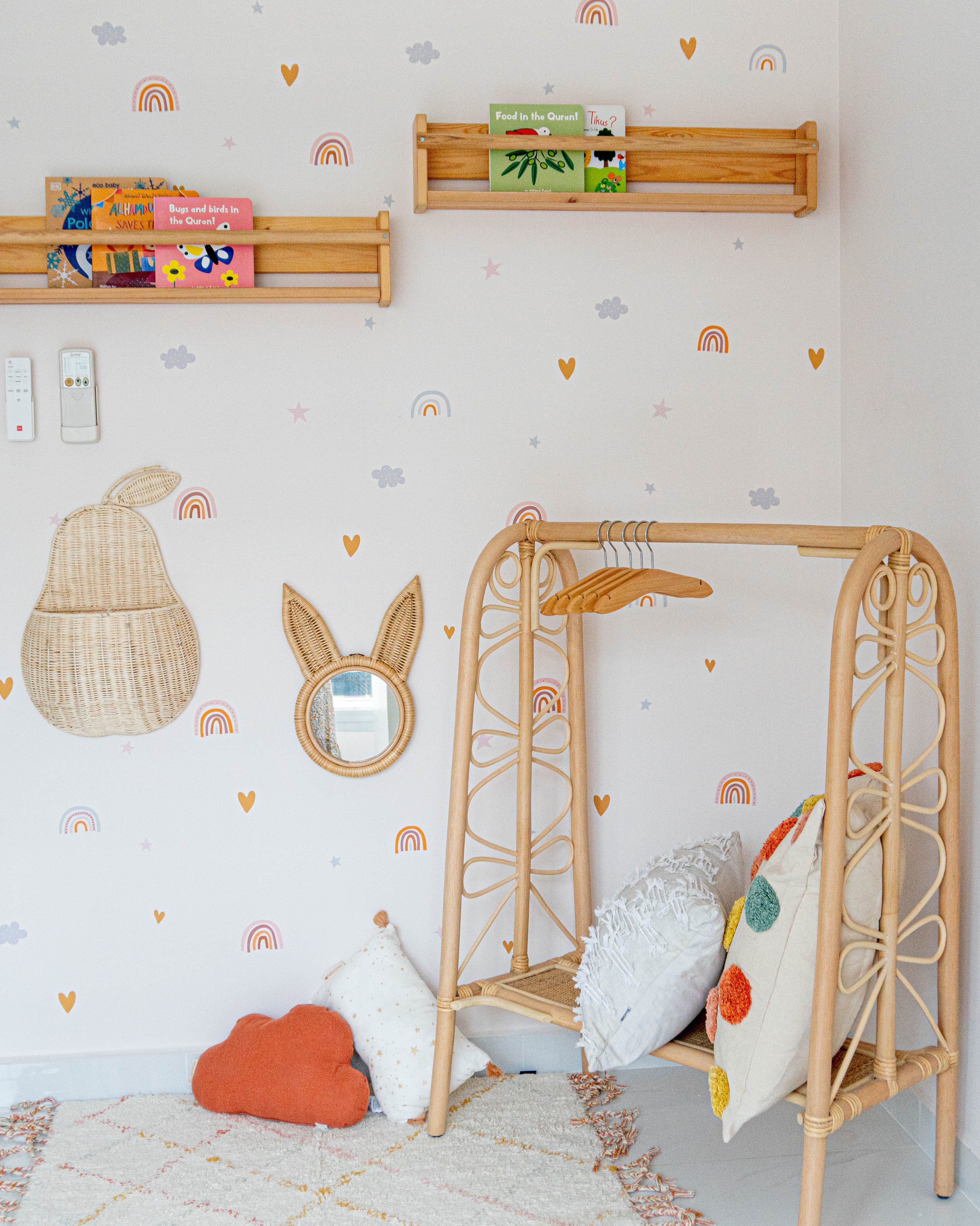 Gender Neutral Kids' Playroom + Girly Dress-Up Room - Wall with playful decorations, wooden crib with colorful pillows