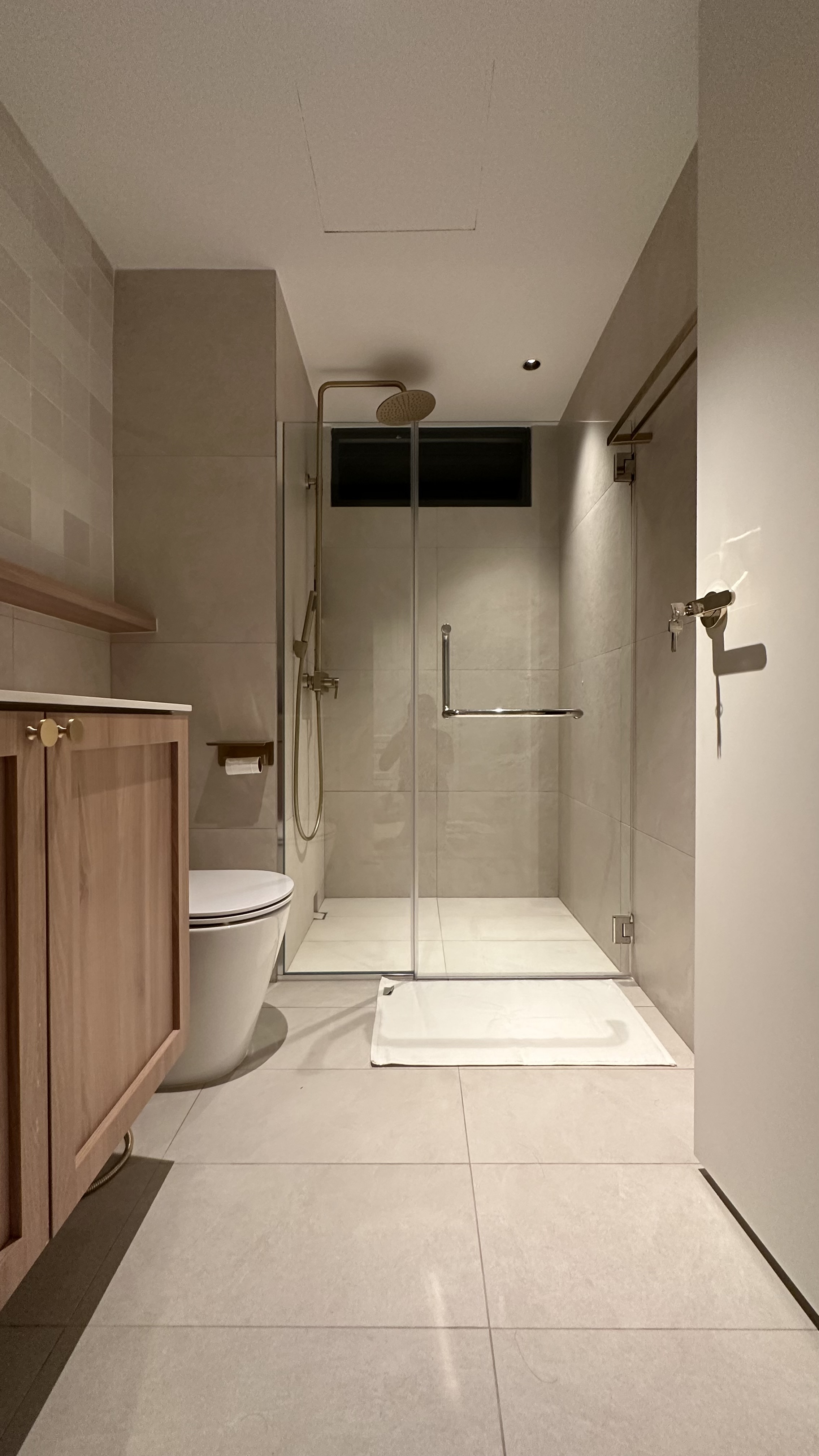 Keeping our bathroom minimal  - Modern minimalist bathroom, sleek design, spacious shower, glass-enclosed shower, wooden