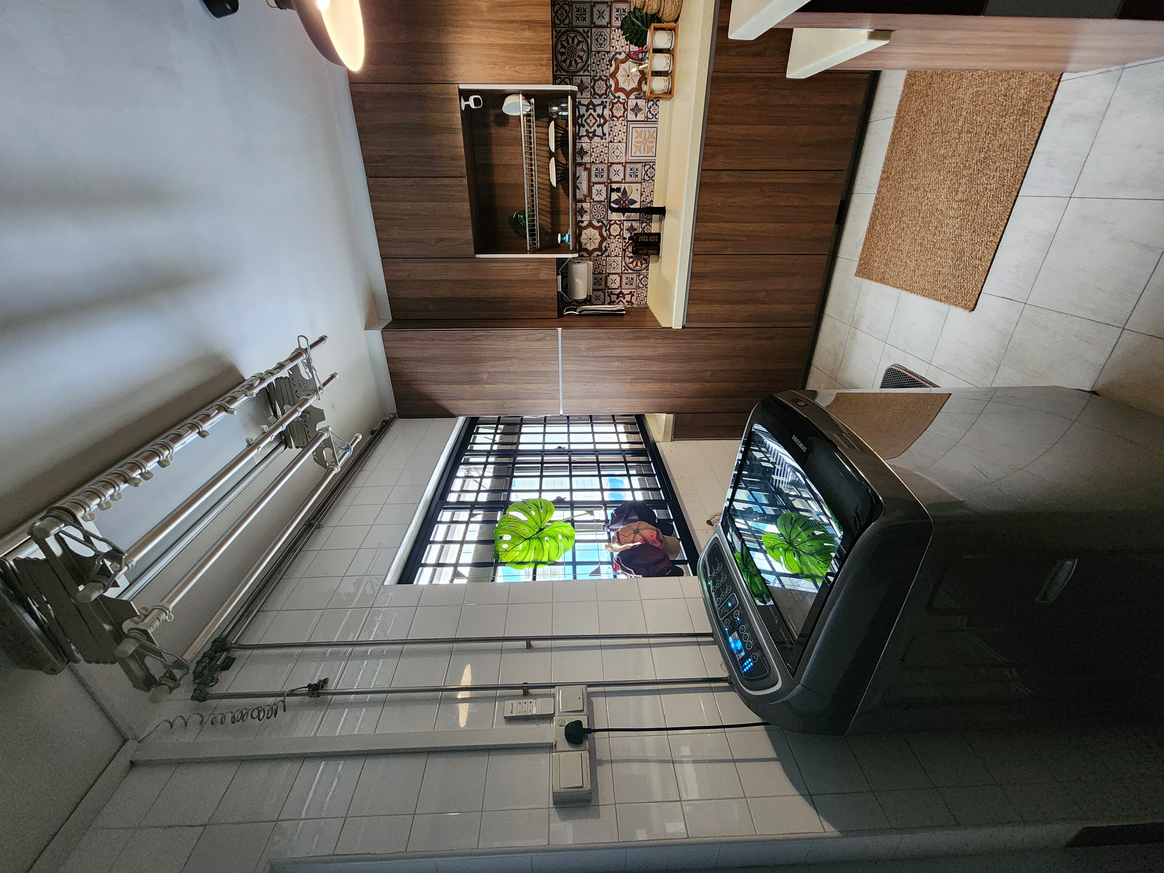 Open concept laundry space - Modern kitchen interior, tiled floor, wooden cabinets, large window, green plants, decorative