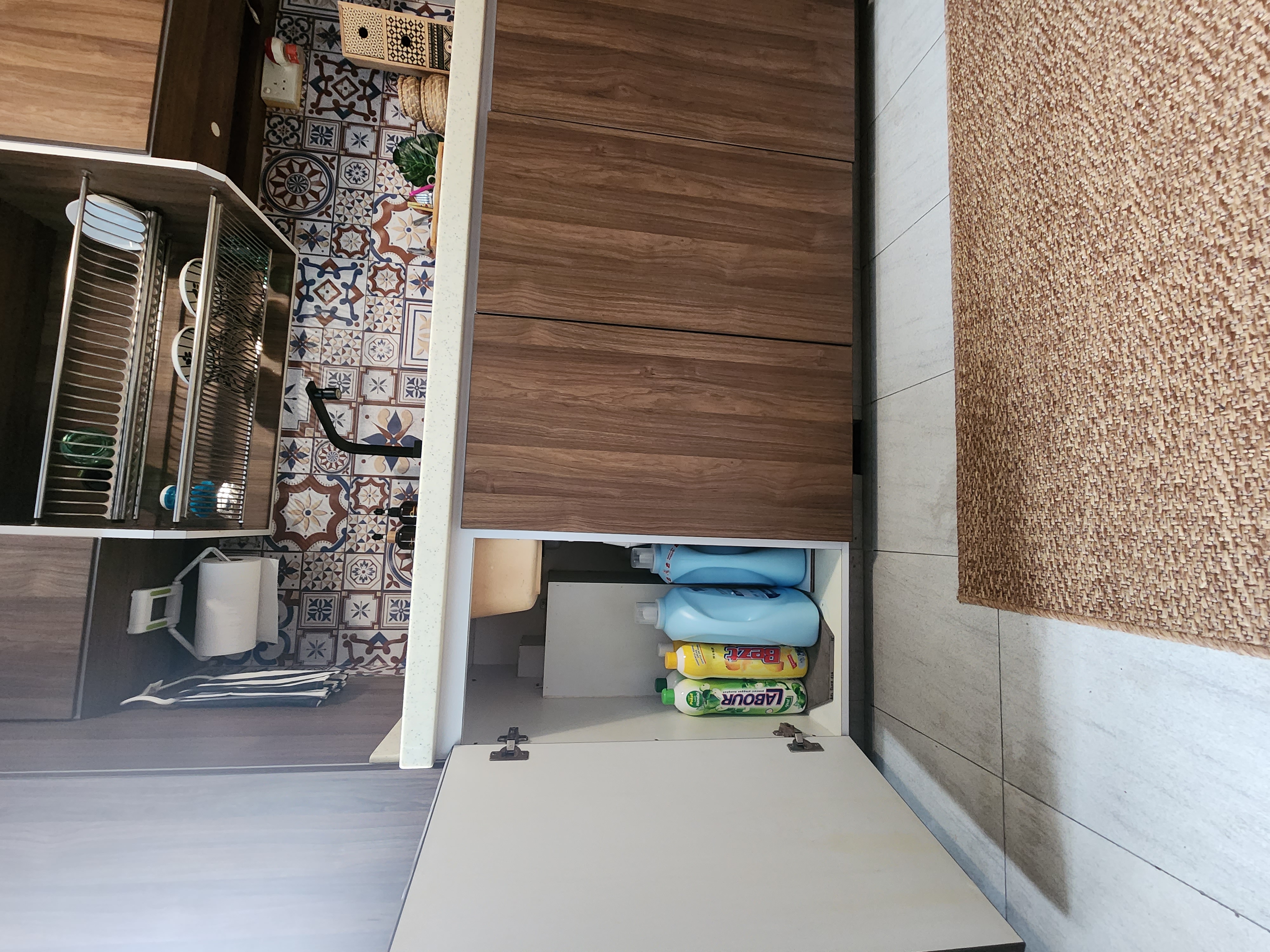 Open concept laundry space - Wooden cabinet, tiled floor, kitchen counter, decorative tiles, wooden panel, open cabinet, blue