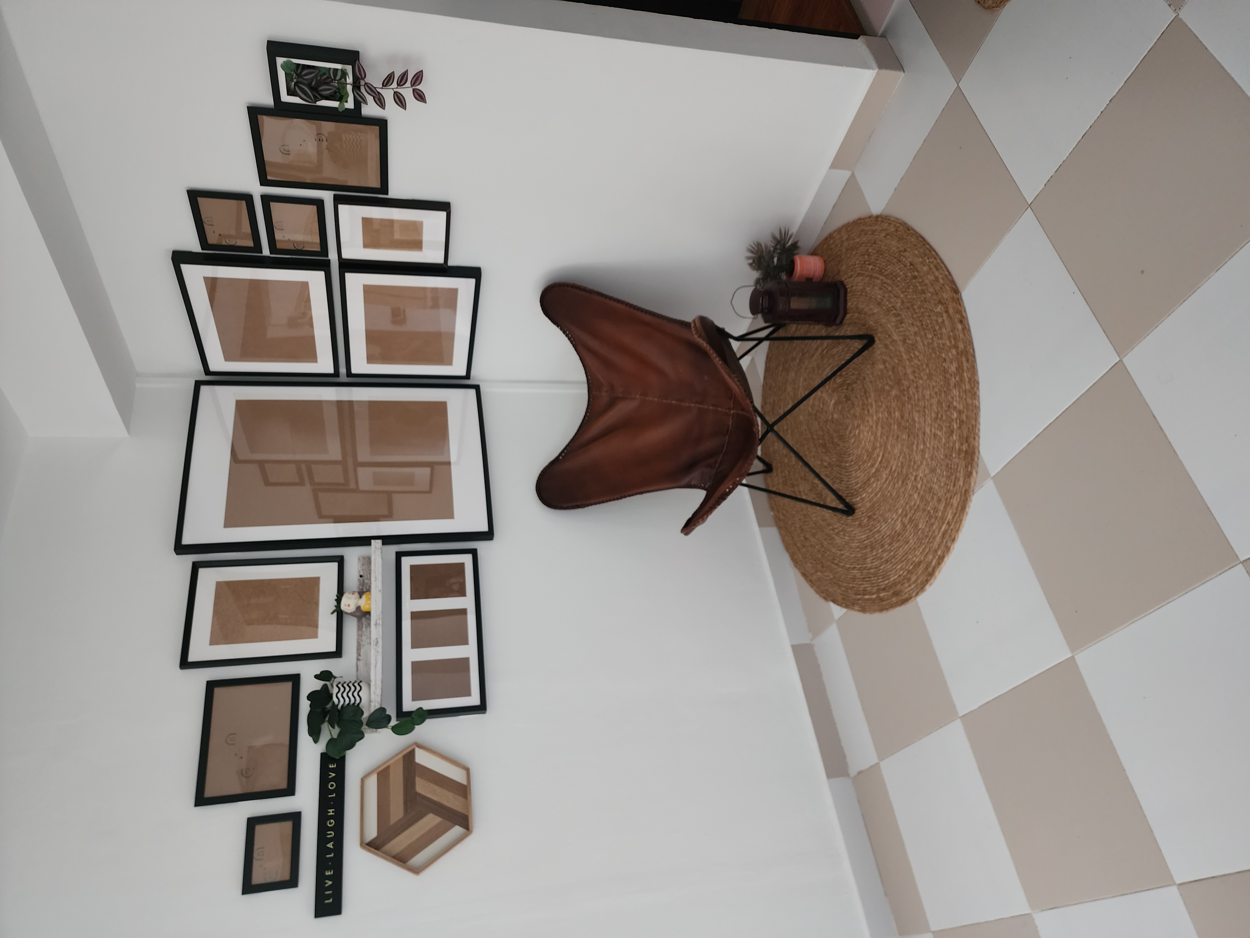 Cosy Corners of our home - Framed pictures, brown leather chair, woven rug, beige and white tiles, geometric pattern