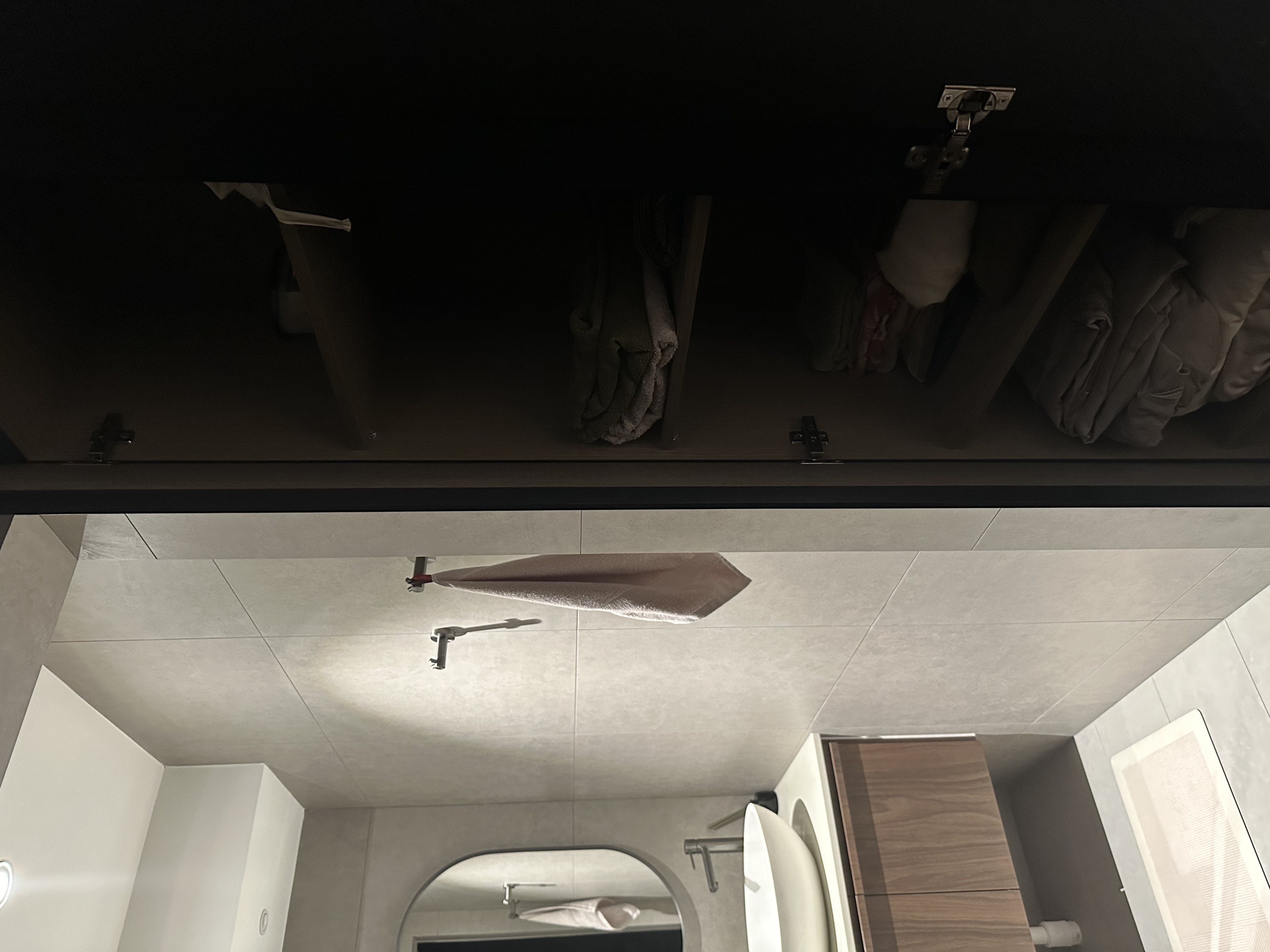 Our hidden common bathroom  - Modern bathroom interior, minimalist design, sleek cabinets, tiled floor, large mirror, white