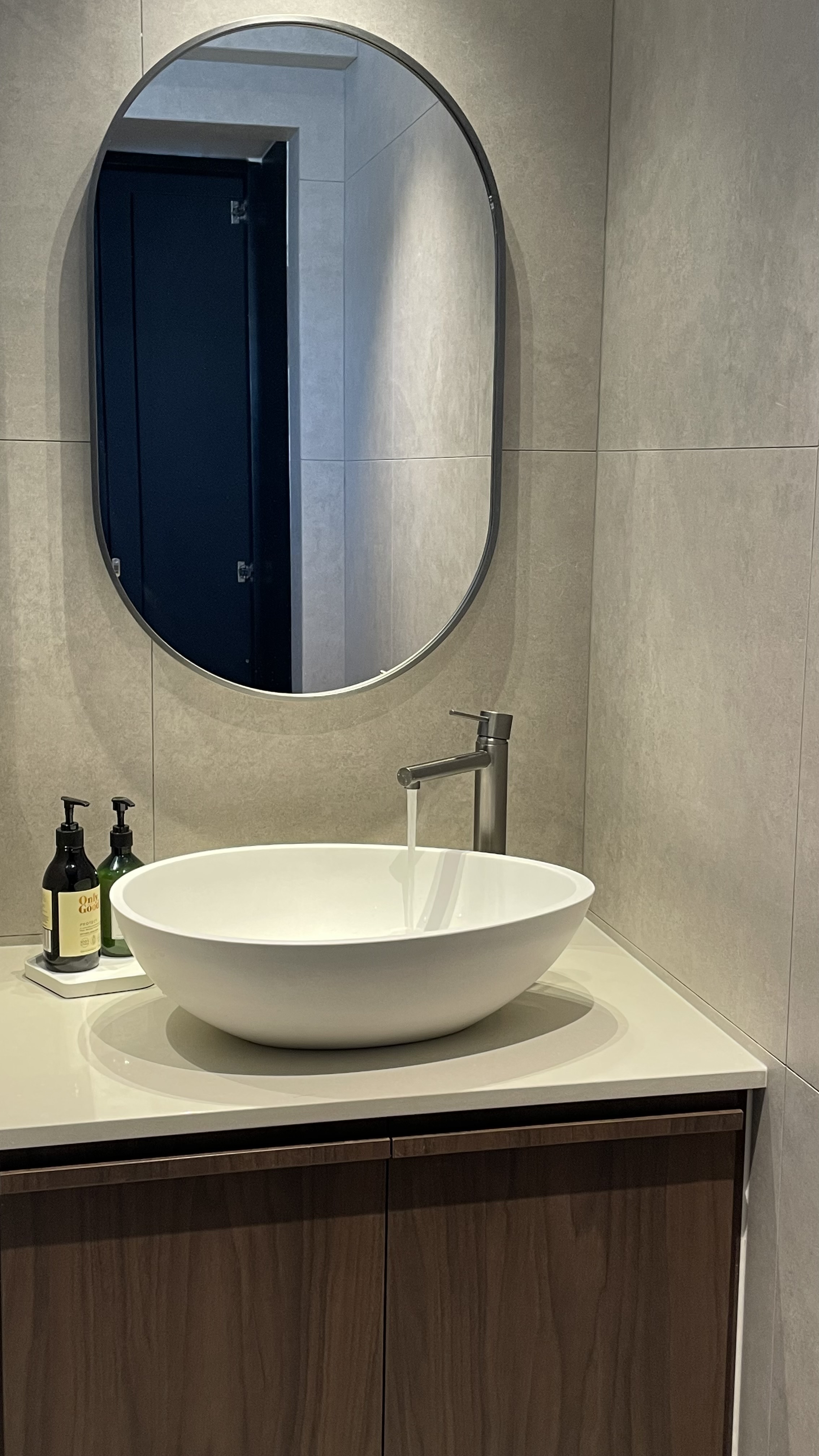 Our hidden common bathroom  - Modern bathroom vanity, sleek sink, oval mirror, minimalist design, white ceramic sink