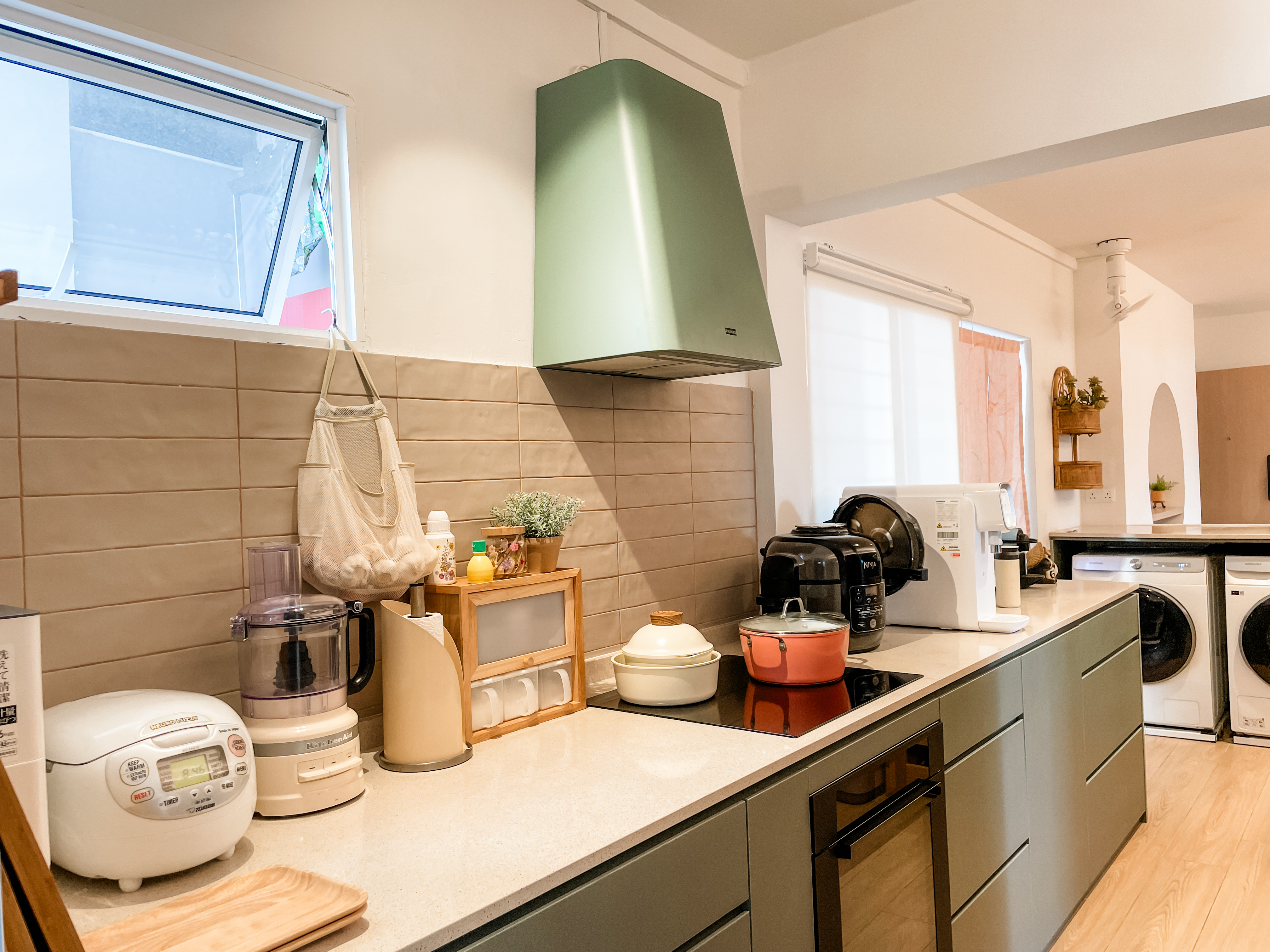 Standout Spots in Our Space - Kitchen countertop, modern appliances, white rice cooker, wooden utensil holder, green wall