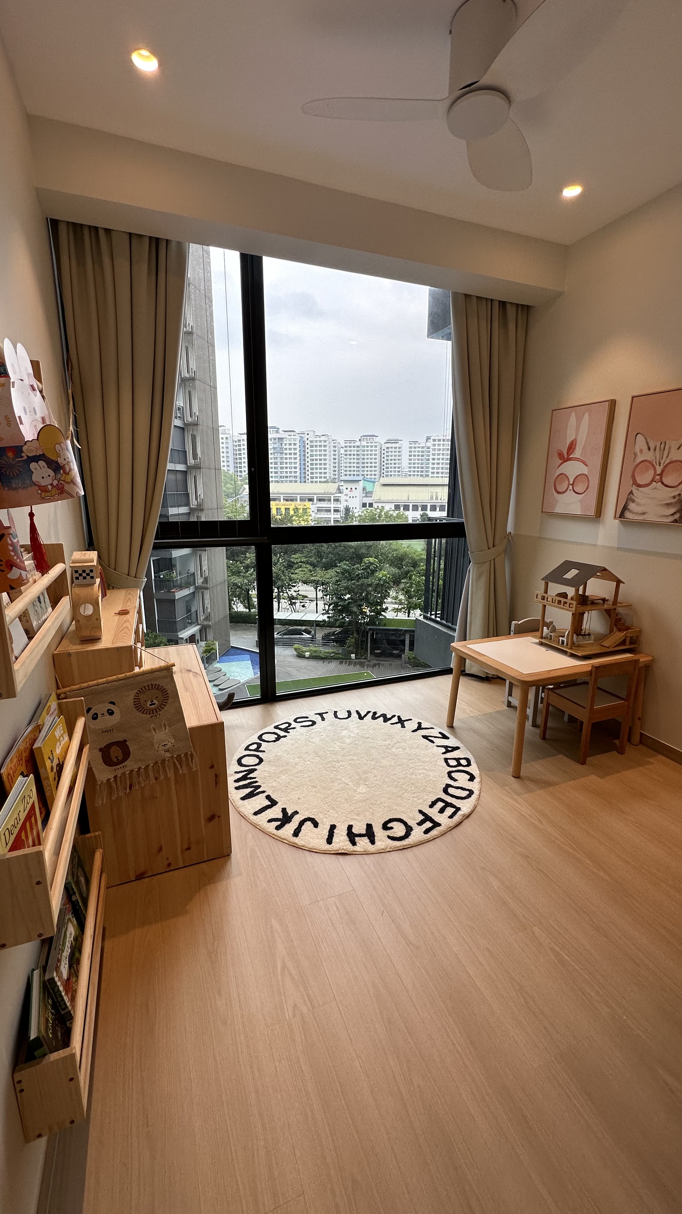 Flexible playroom that will grow with the kids - Wooden shelves, bookcases, and decorative items, beige curtains, circular