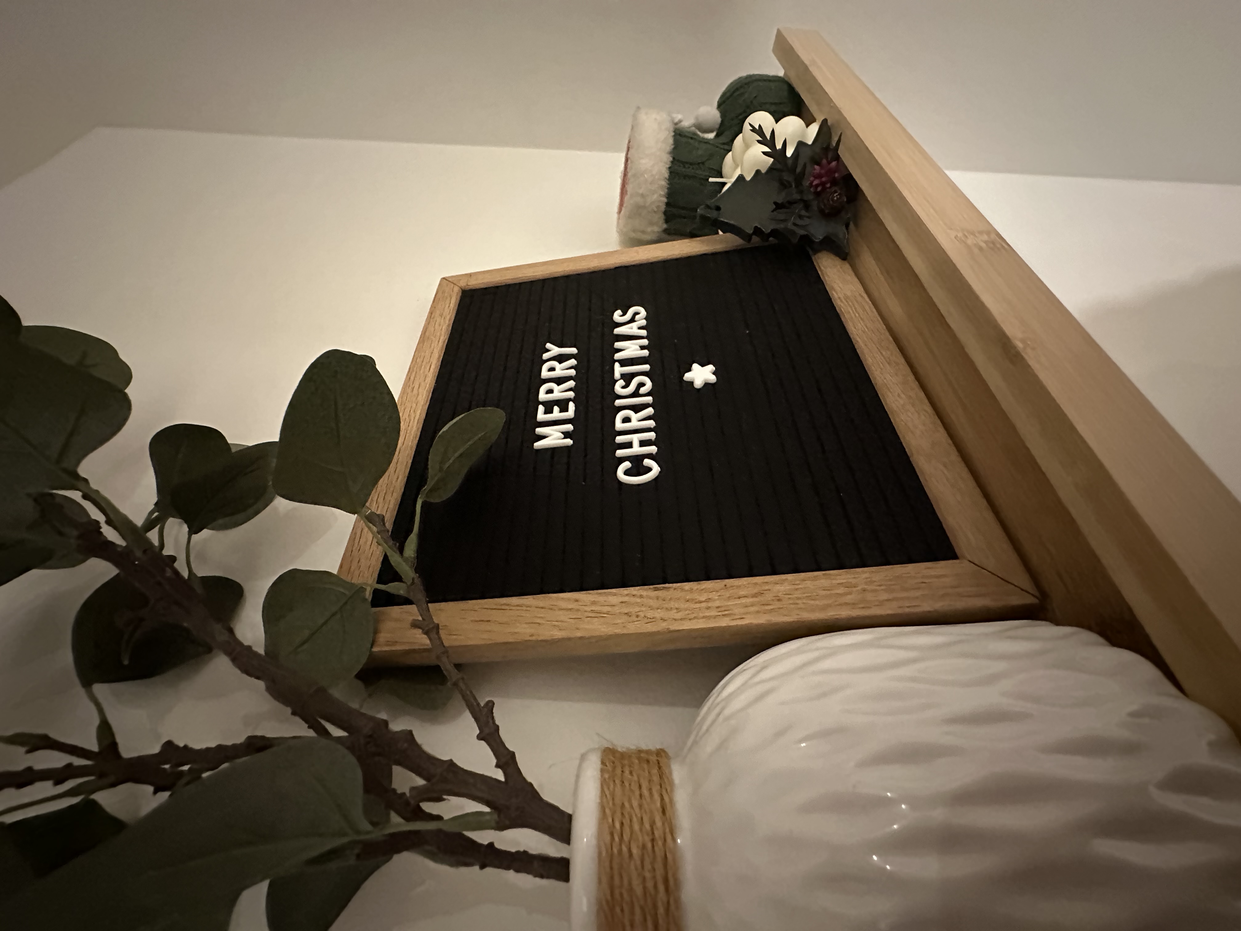 Entryway - The first impression of our home - wooden frame, black mat, "Merry Christmas" text, green leaves, white pine cone