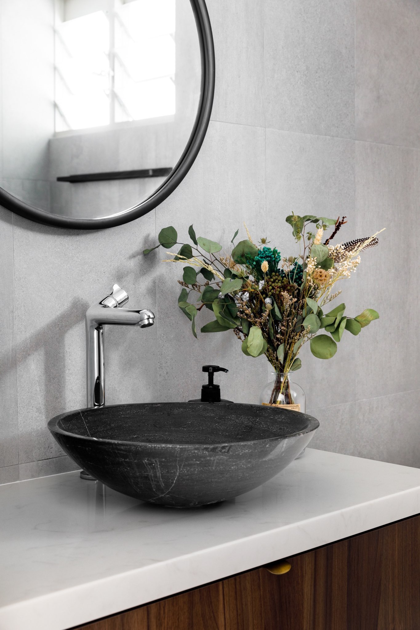A Minimalist & Industrial Look For A Young Couple - modern bathroom vanity, sleek sink, black basin, round mirror, minimalist