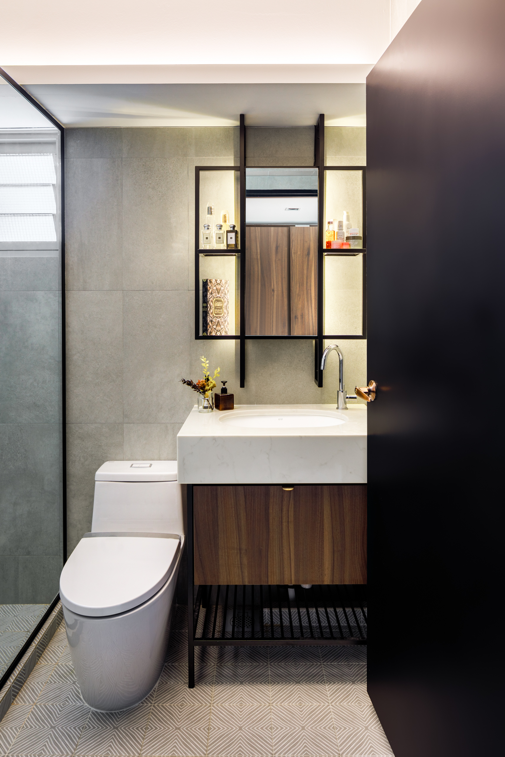 A Minimalist & Industrial Look For A Young Couple - Modern bathroom with sleek design, gray tiles, white toilet, wooden