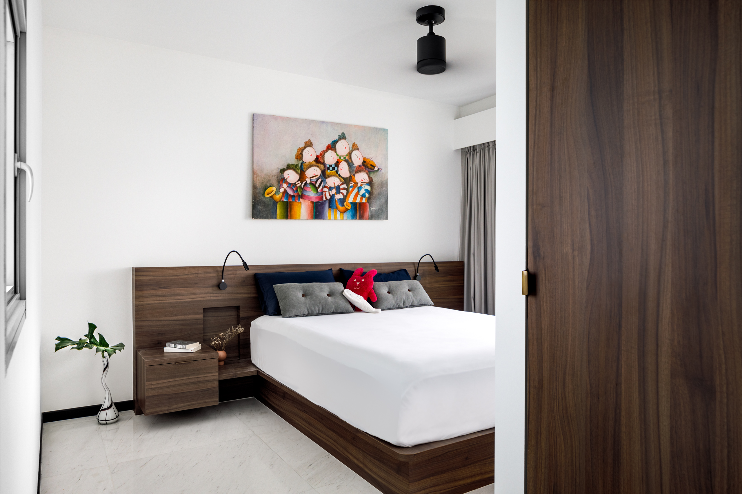 A Minimalist & Industrial Look For A Young Couple - Modern bedroom with wooden furniture, white walls, colorful abstract