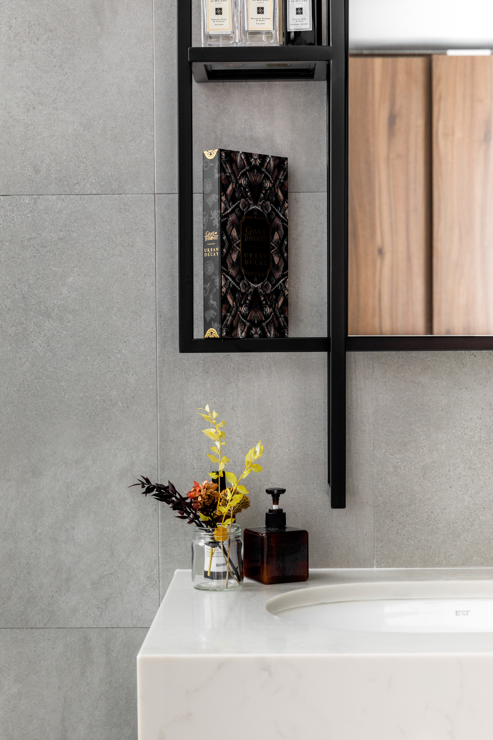 A Minimalist & Industrial Look For A Young Couple - Gray marble wall, black shelf, elegant black book, "Game of Thrones"