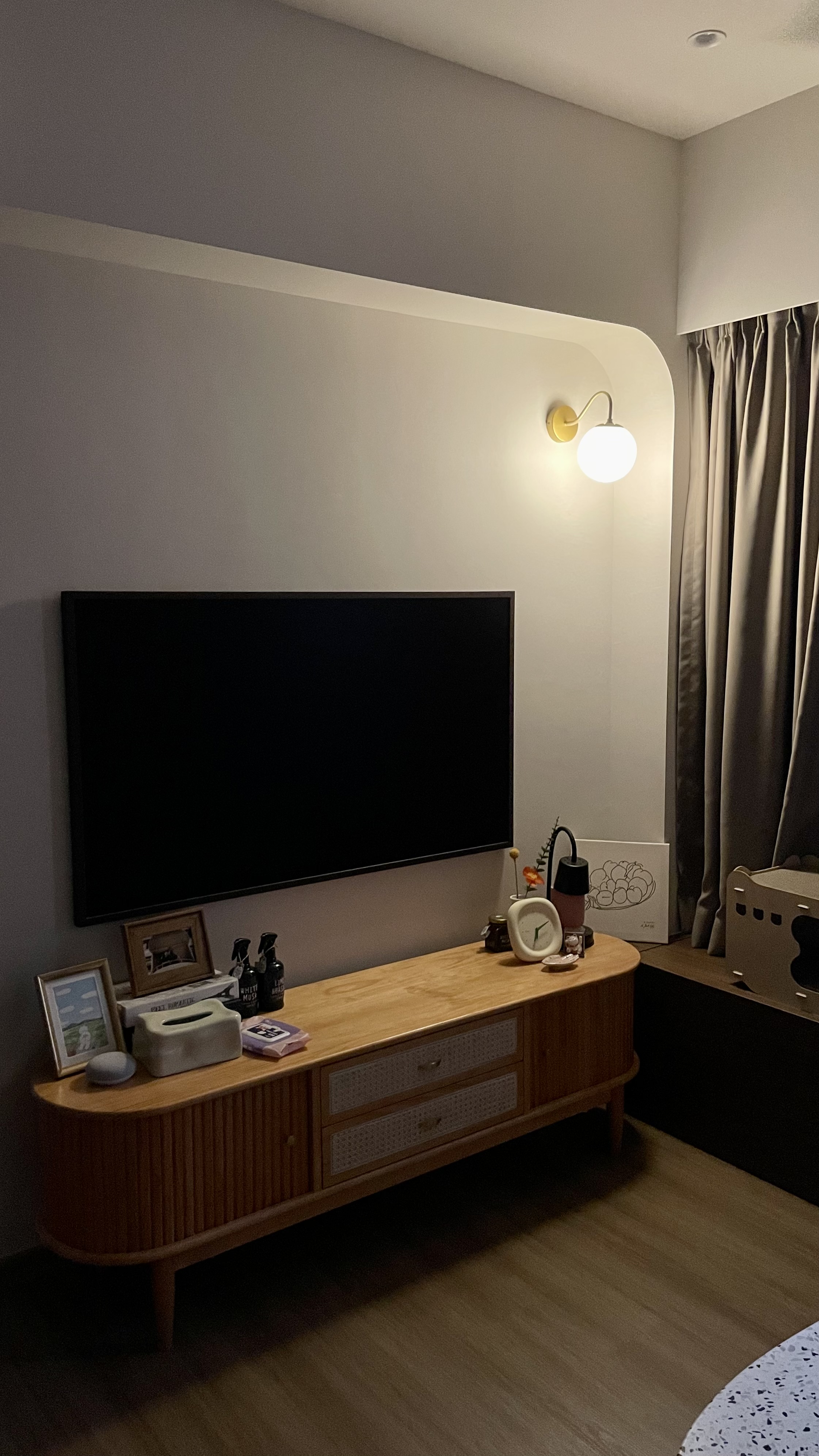 Don’t turn on the big lights 💡 - Wooden TV stand, black flat-screen TV, minimalist decor, soft lighting, cozy room, modern