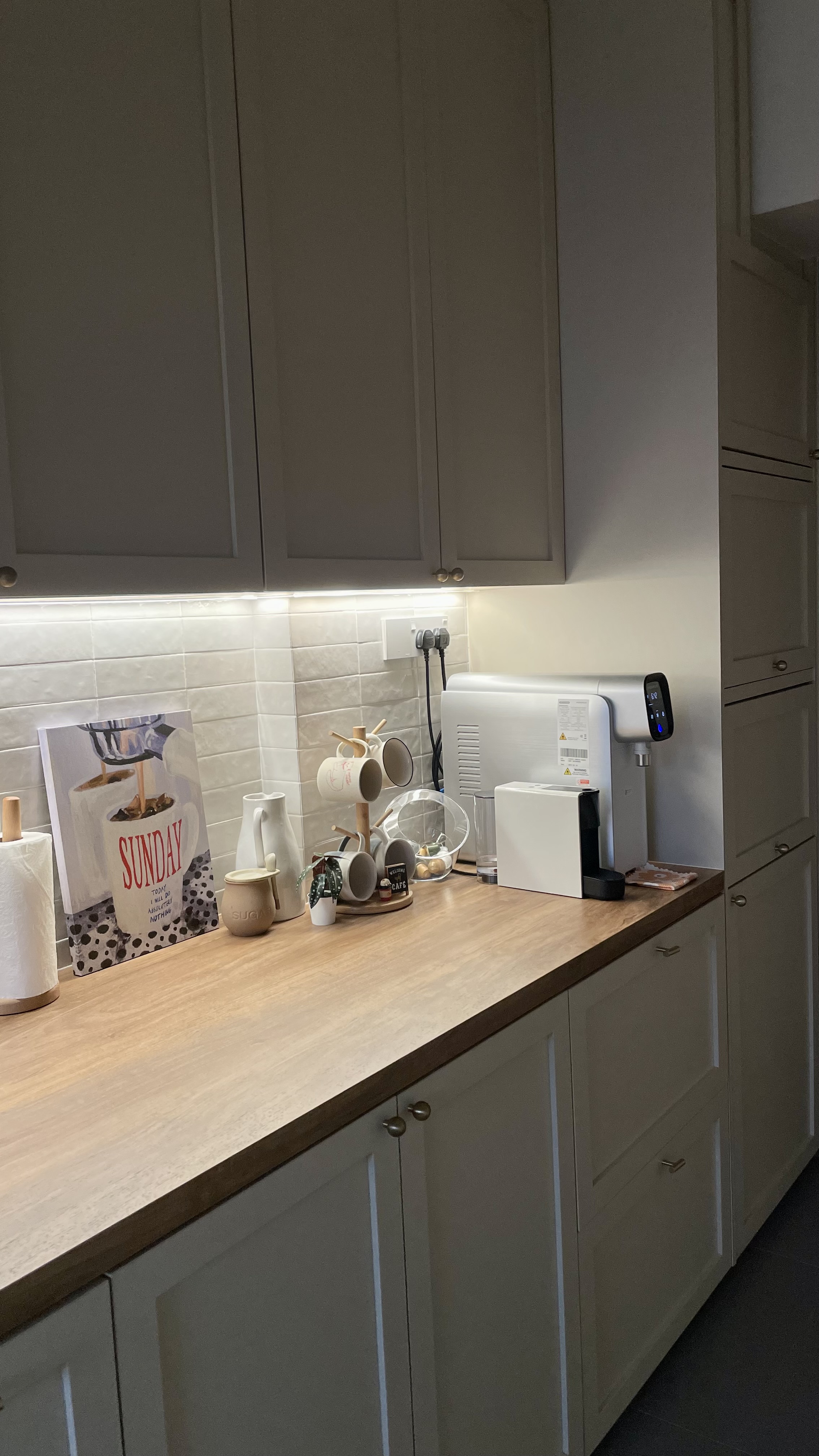 Don’t turn on the big lights 💡 - coffee maker, coffee machine, white ceramic mug, wooden countertop, kitchen cabinets