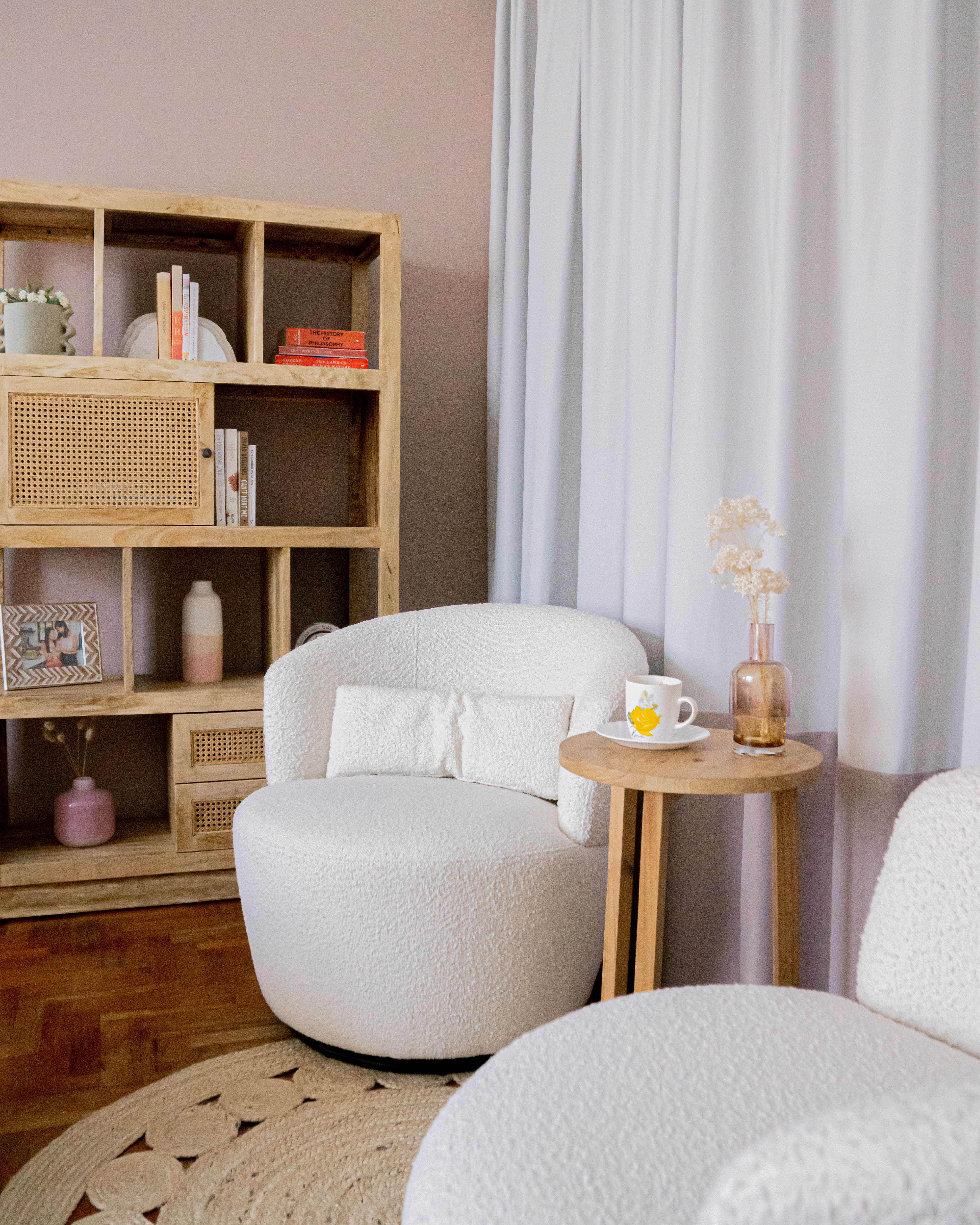 Cosy Luxurious Master Bedroom Transformation - Wooden bookshelf, white armchair, soft pink wall, white curtains, wooden side