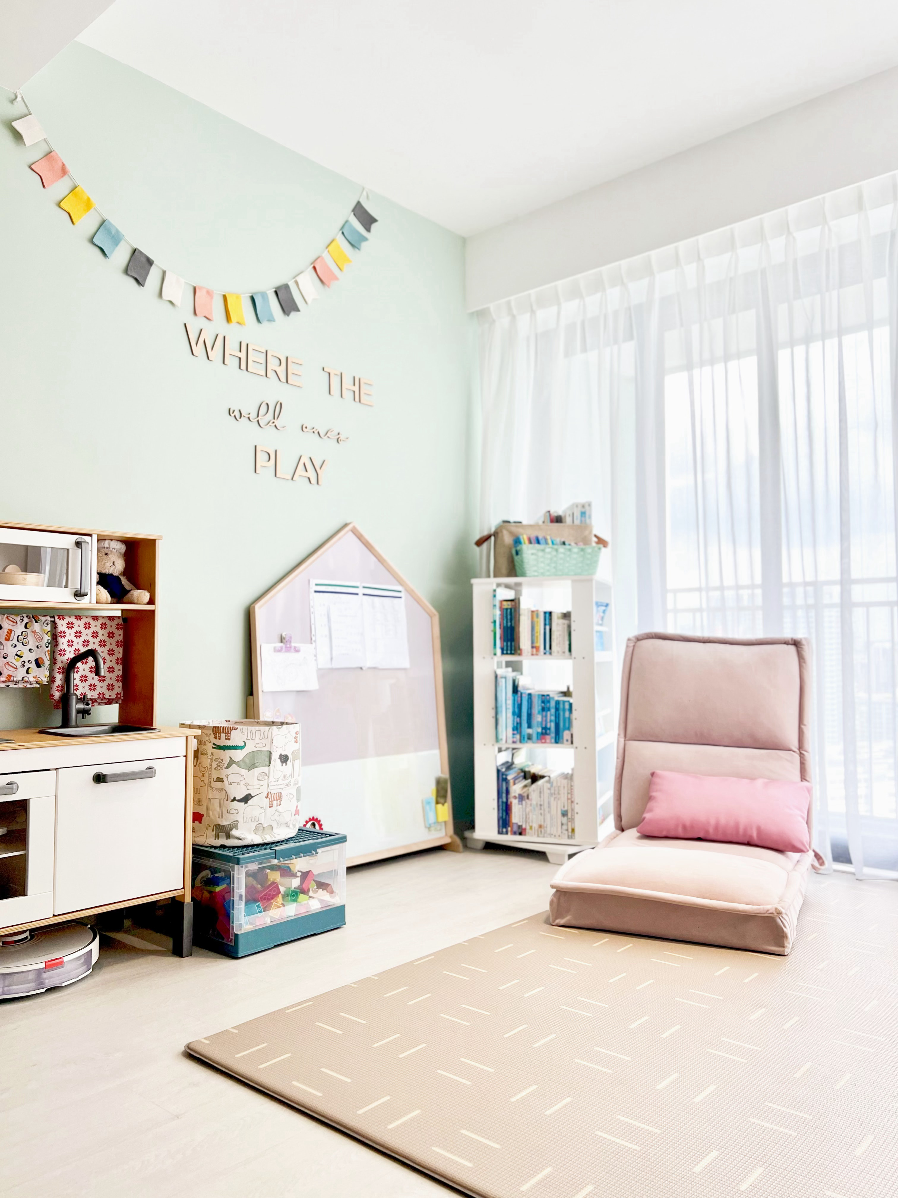 Create Cosy Corners Everywhere! - Light green wall, colorful pennants, playful decor, "Where the will always play" sign