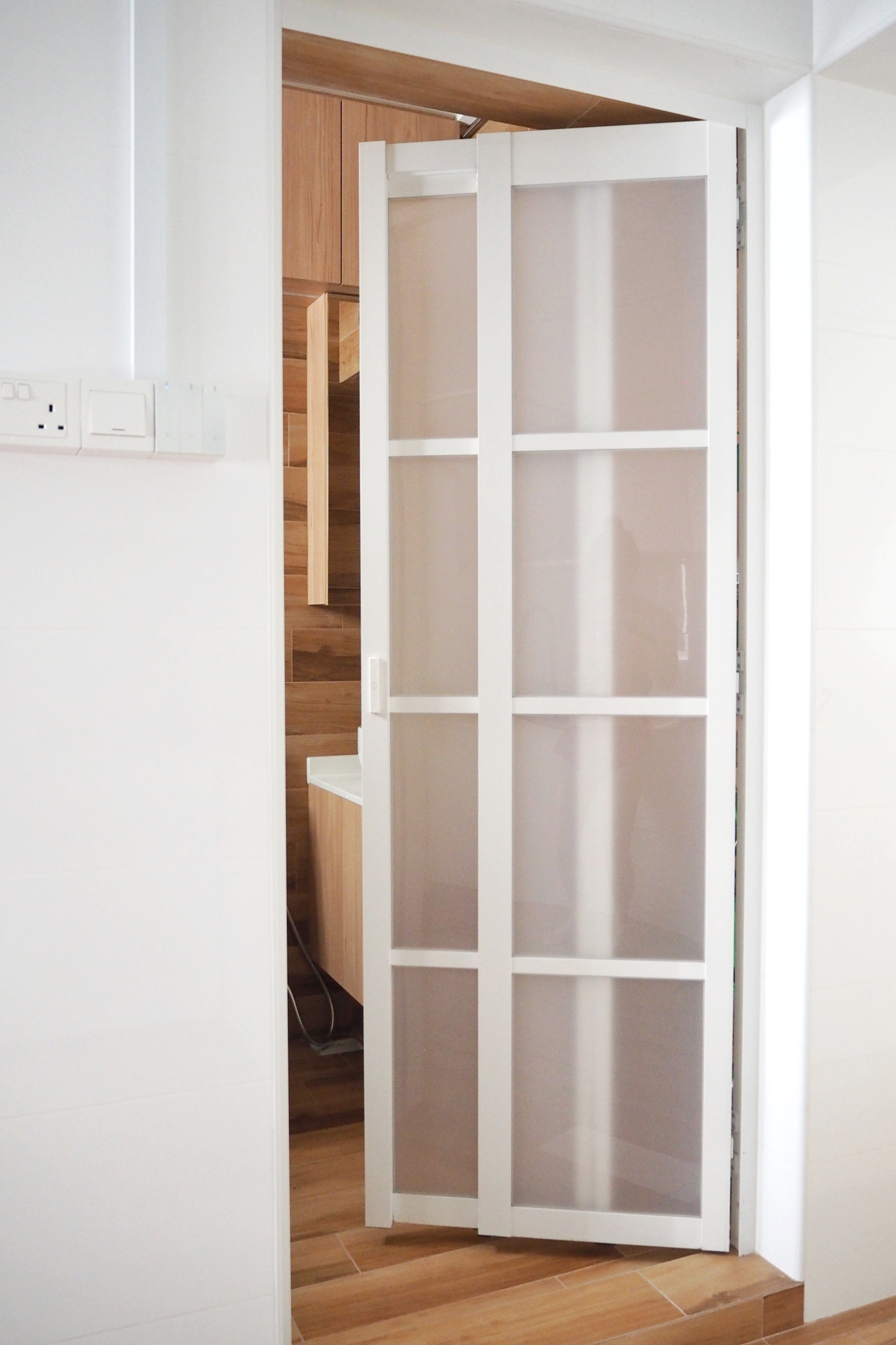 A how-to guide: Maximising limited space at home - Wooden cabinets, white door, glass panels, modern design, minimalist