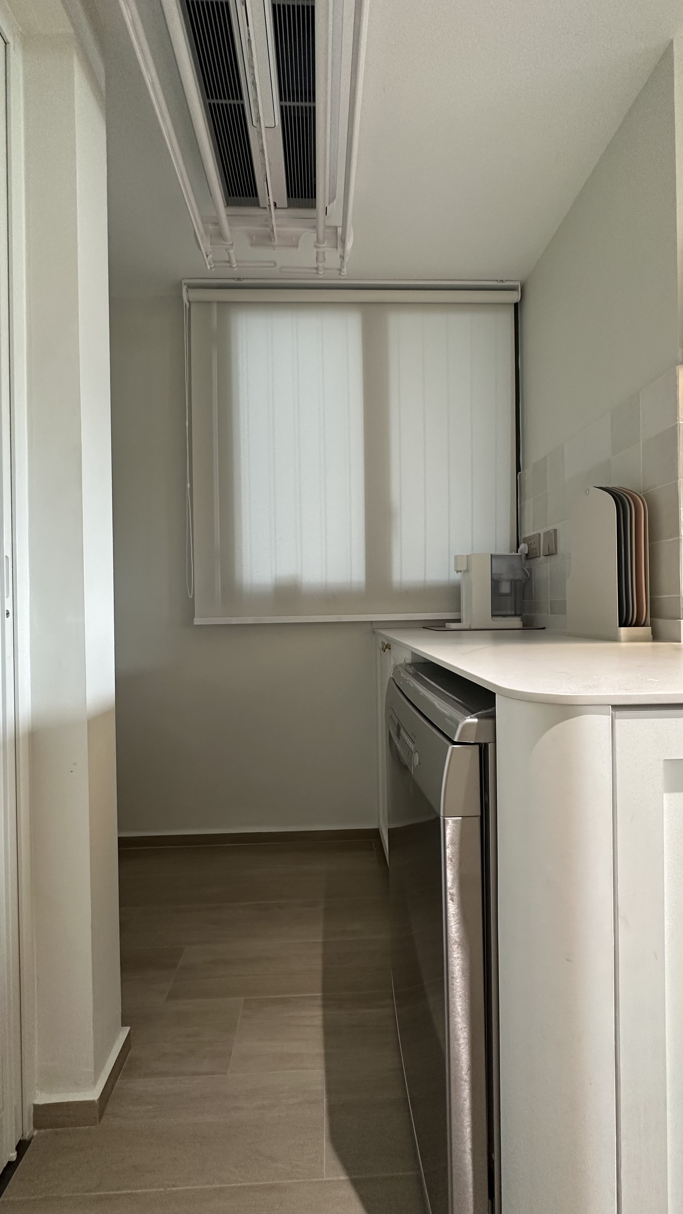 Our dual function yard - Modern kitchen with sleek white cabinetry, stainless steel appliances, light gray walls, tiled