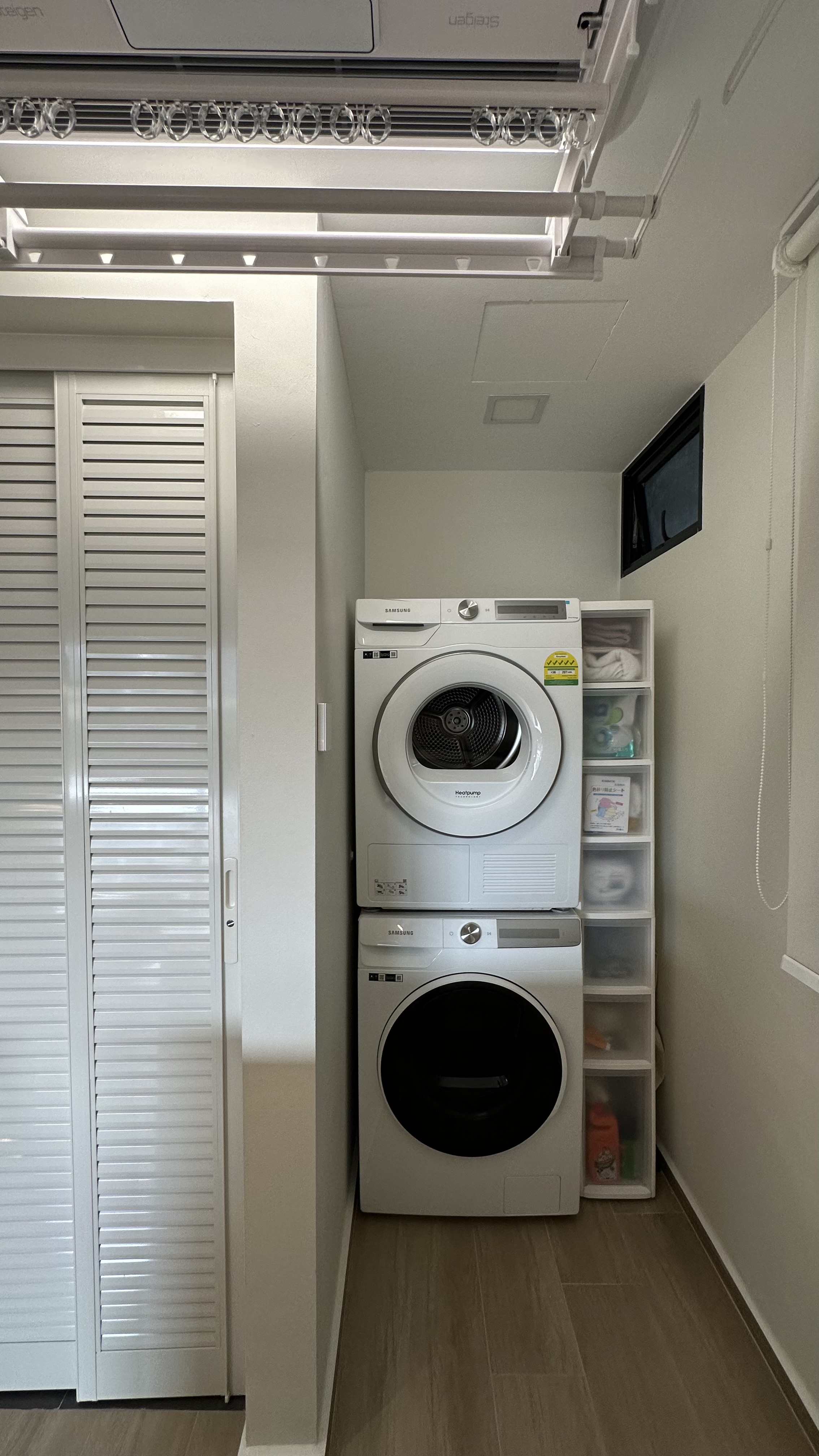 Our dual function yard - laundry room, stacked washer and dryer, modern laundry setup, white Samsung washing machine, white