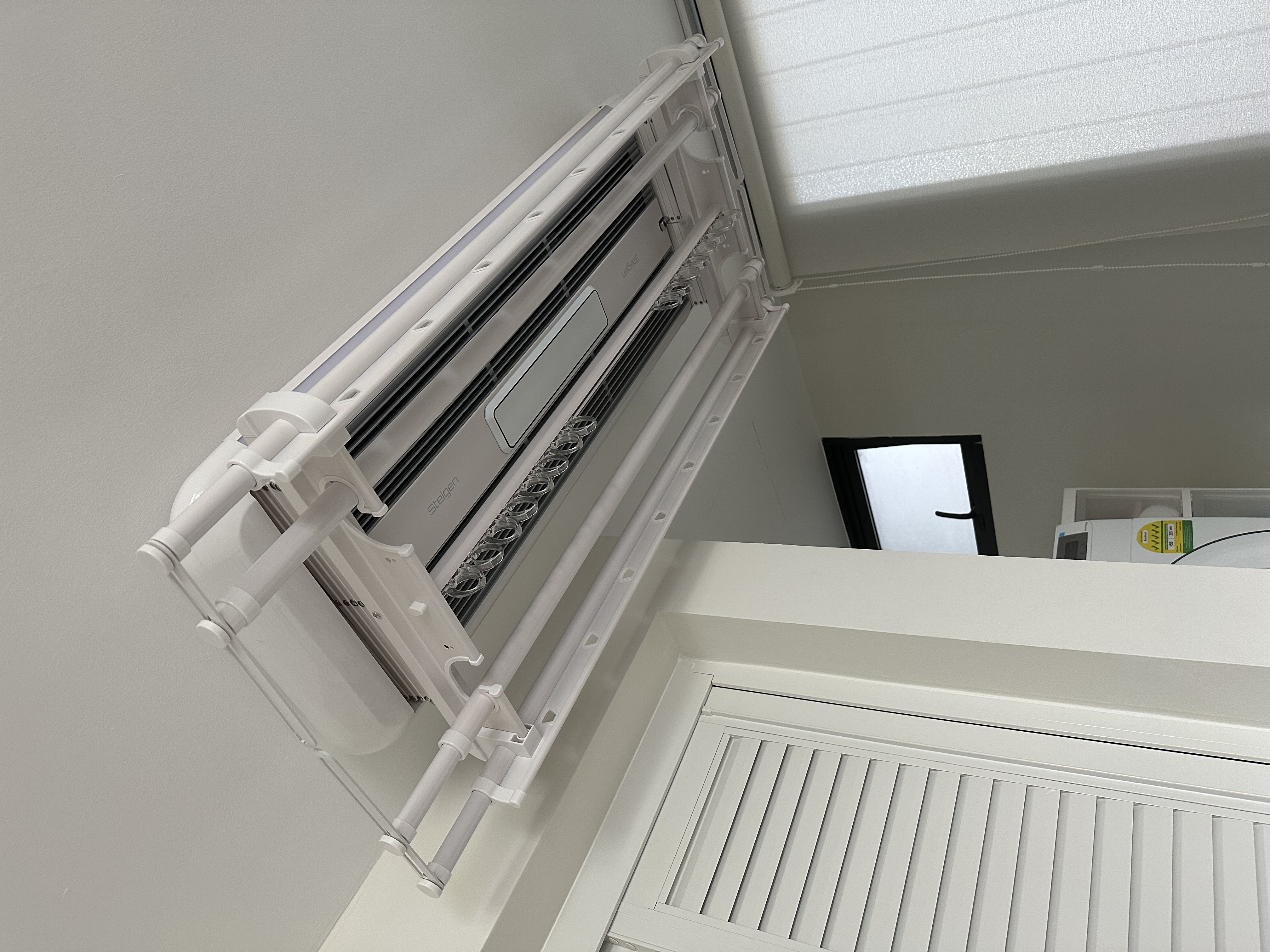 Our dual function yard - Air conditioning unit mounted on wall, white frame, ventilation ducts, ceiling-mounted, modern