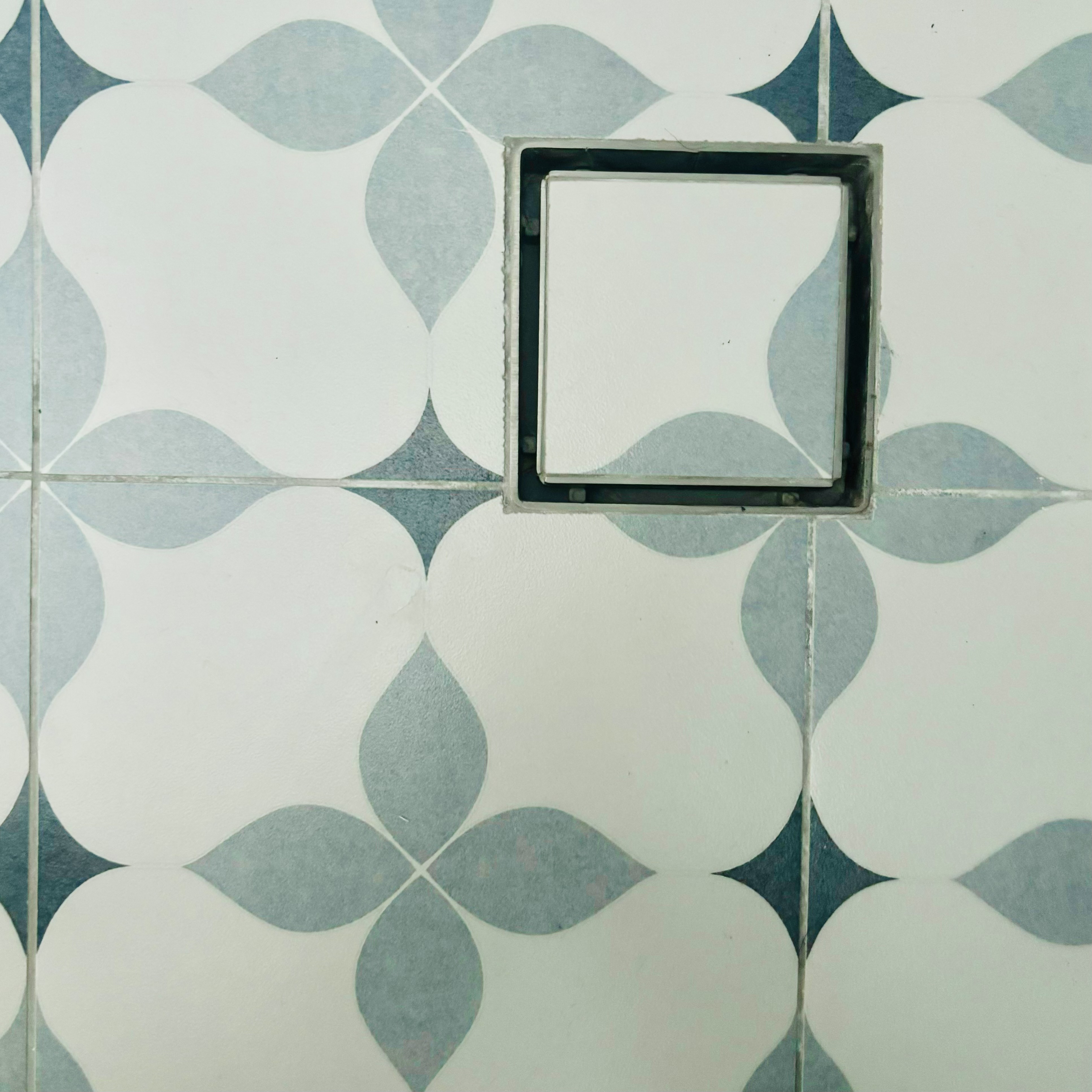 Two toilets, two different themes ✨ - Geometric tiles with abstract shapes, square tile frame, white and blue pattern