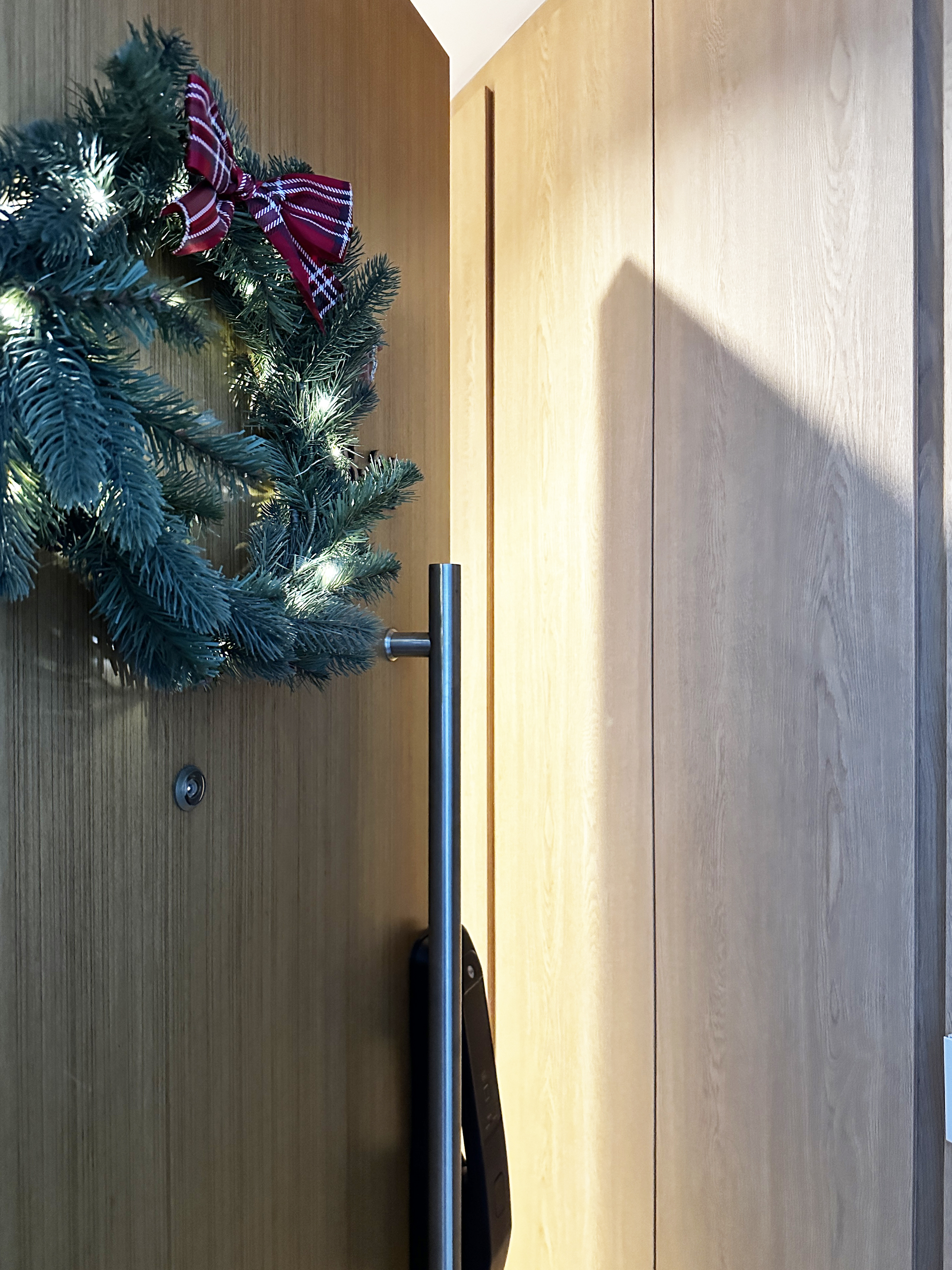 Our entryway with ample storage space - Christmas wreath, green pine branches, festive decorations, red and white checkered