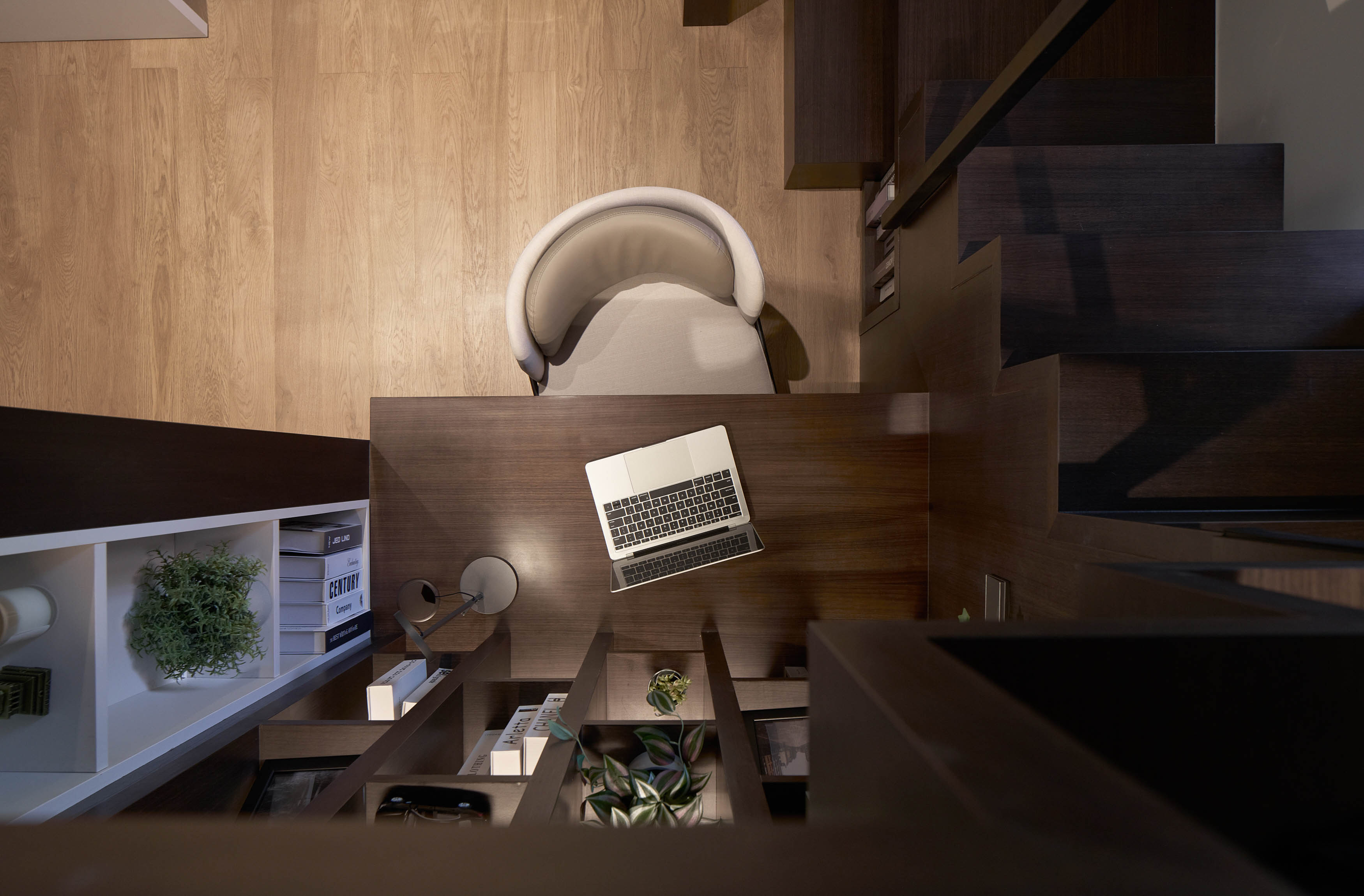 An Elegant And Sophisticated Space  - Wooden floor, modern office, ergonomic chair, dark wooden shelves, plant in pot, desk