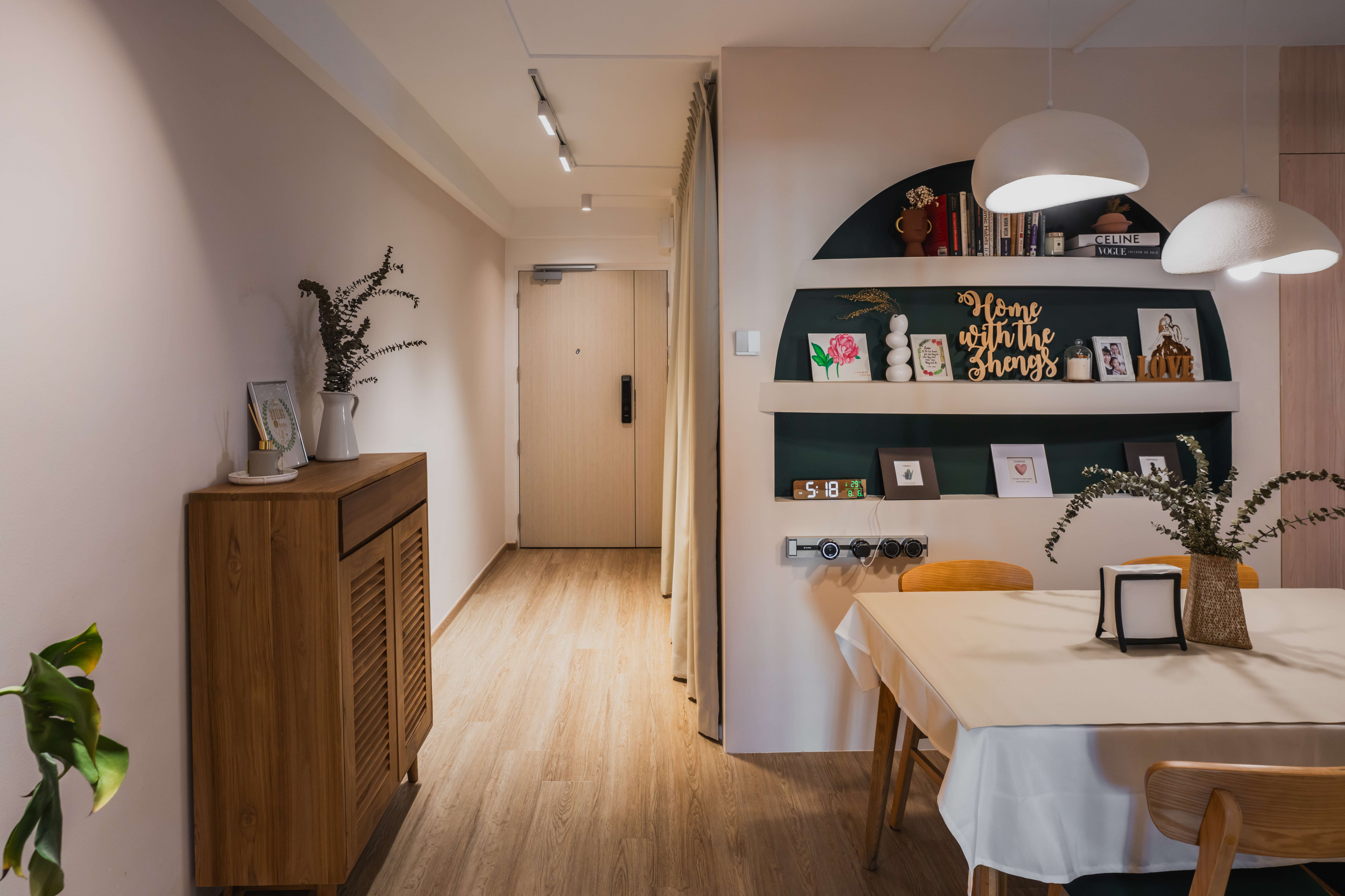 Entryway: Graceful curves and cozy ambience  - Wooden cabinet, dining table, white tablecloth, wooden chairs, potted plant