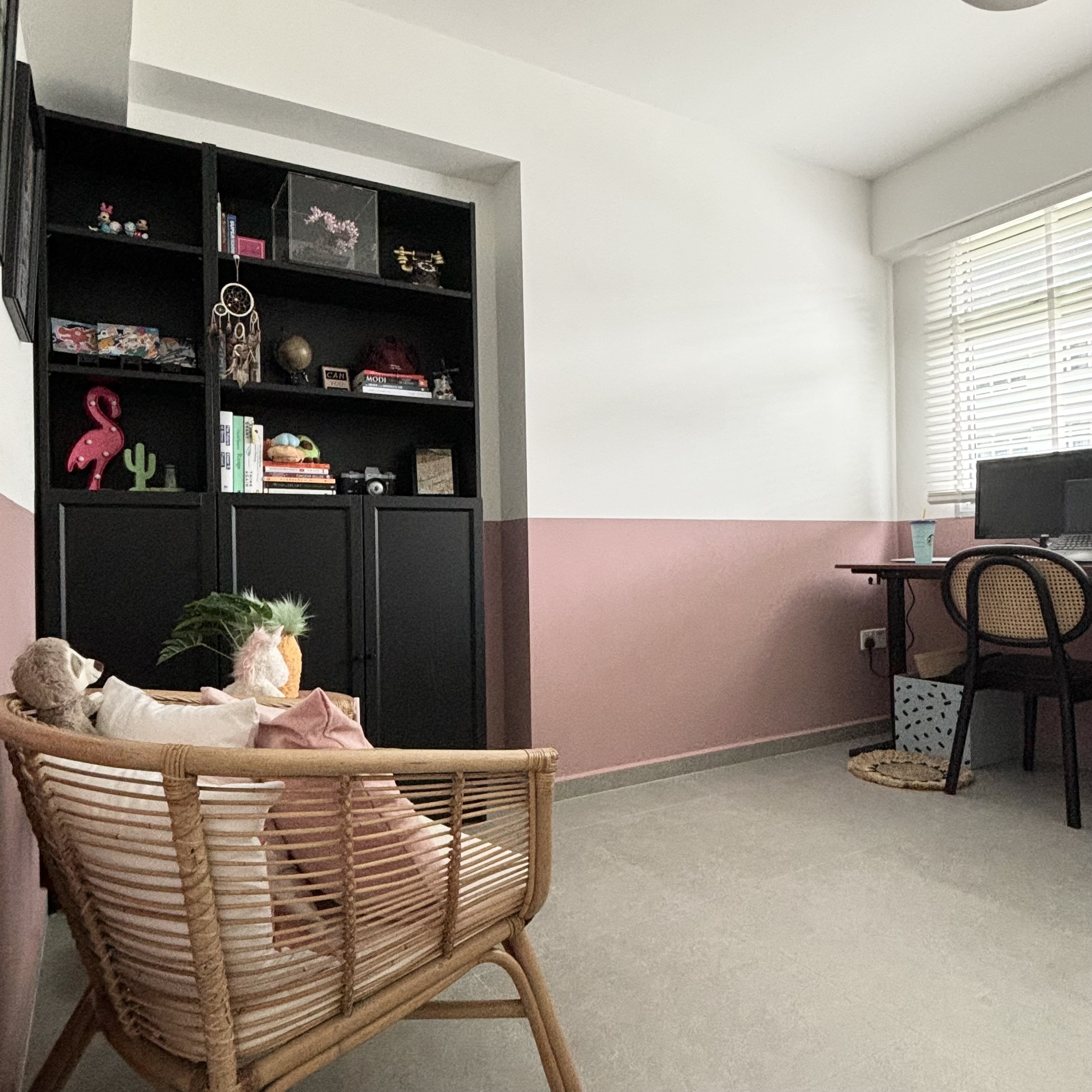 Study room with a pop of colour! - Woven chair, pink and white walls, black bookshelf, decorative items, plush toys, indoor