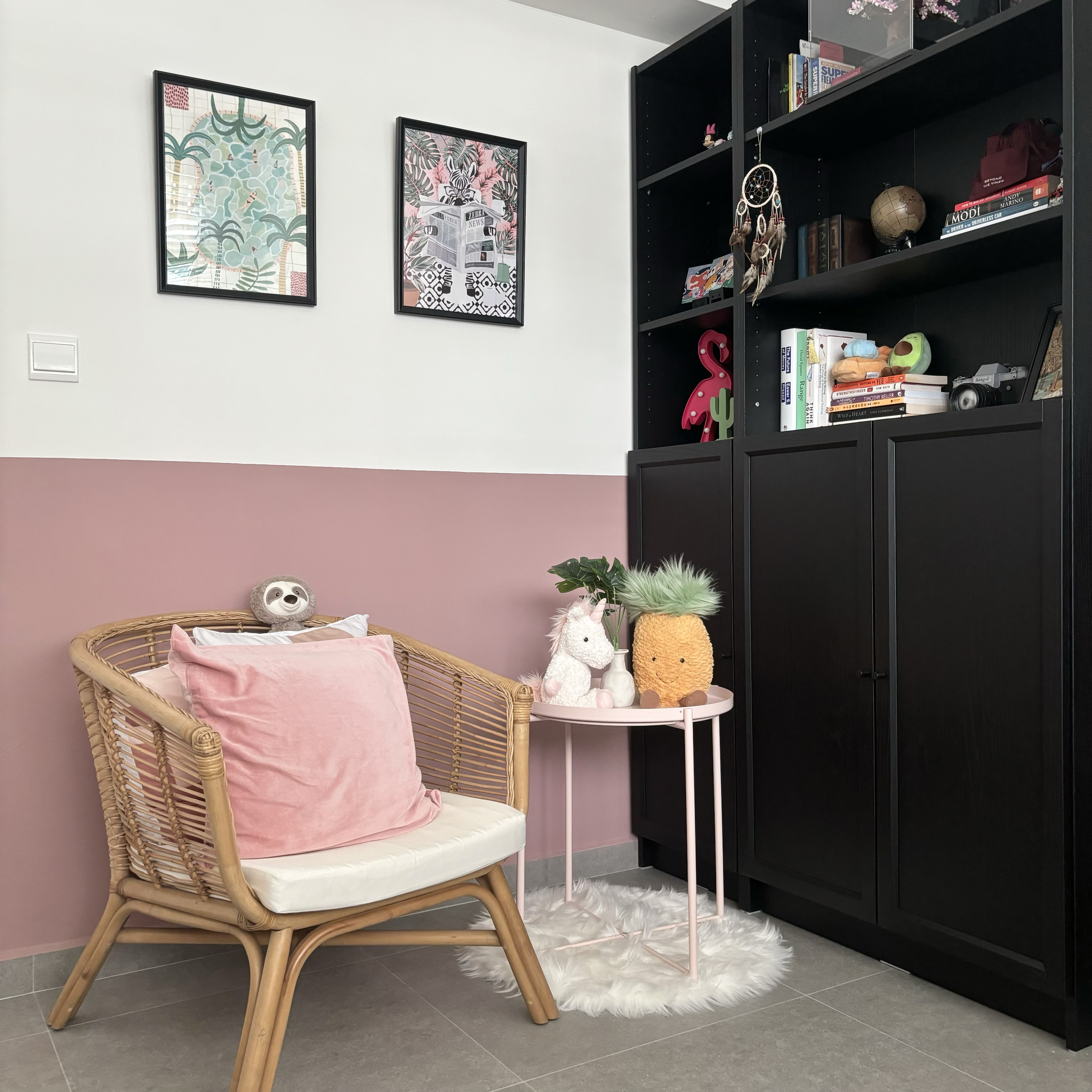 Study room with a pop of colour! - Woven wicker chair with pink cushion, small white unicorn and pineapple toys on round