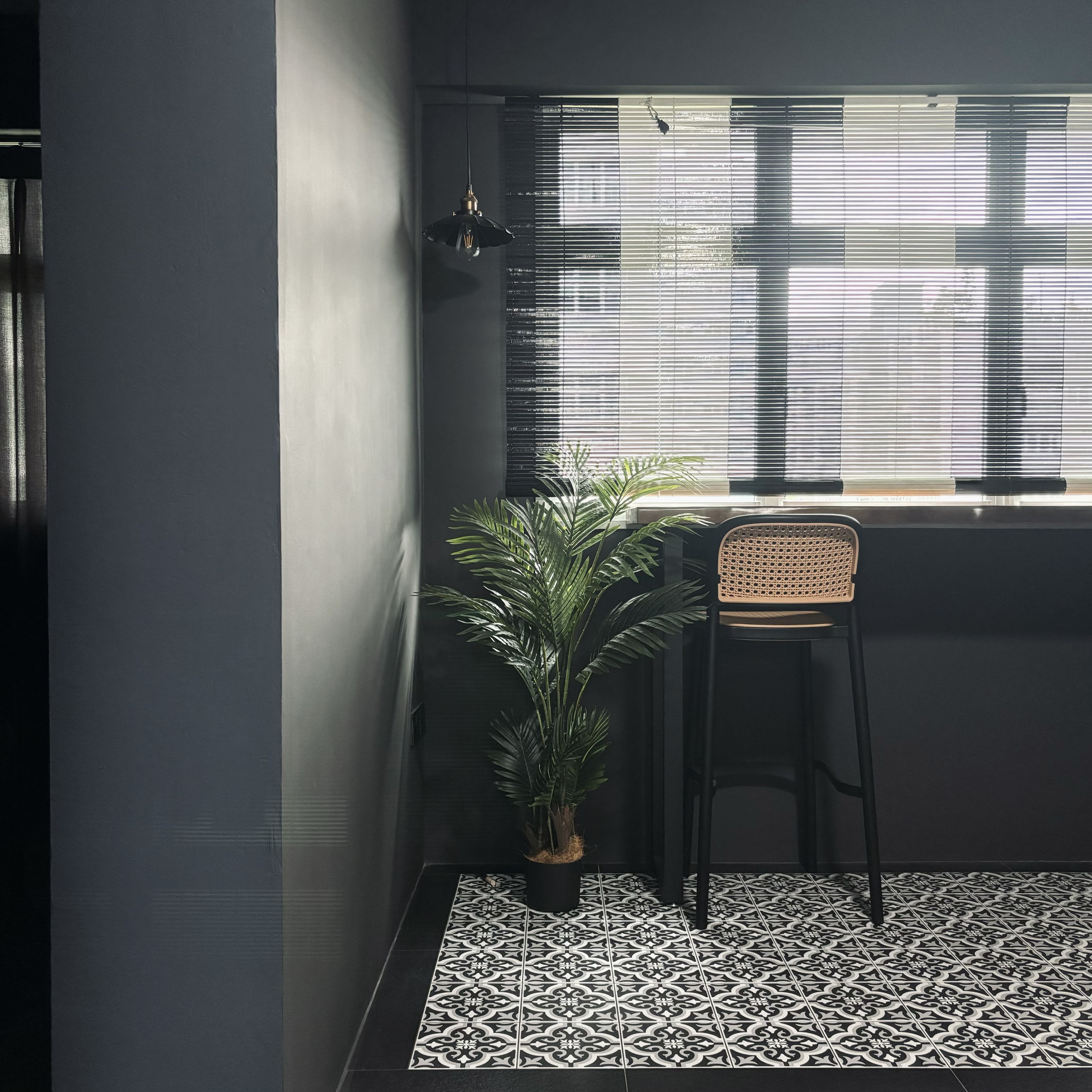 Our version of recreational area - the "balcony" - modern minimalist interior, sleek black chair, geometric patterned tiles