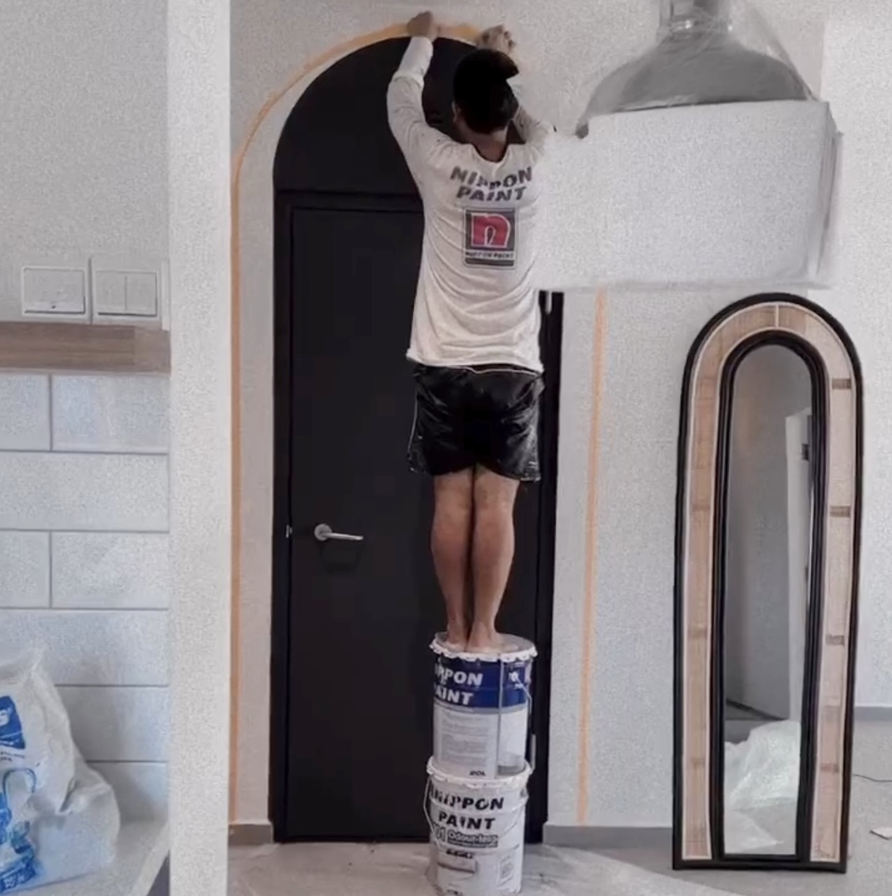 Entryway - cheap way to hide the ugly bomb shelter door! - standing man painting wall, painting process, painting technique