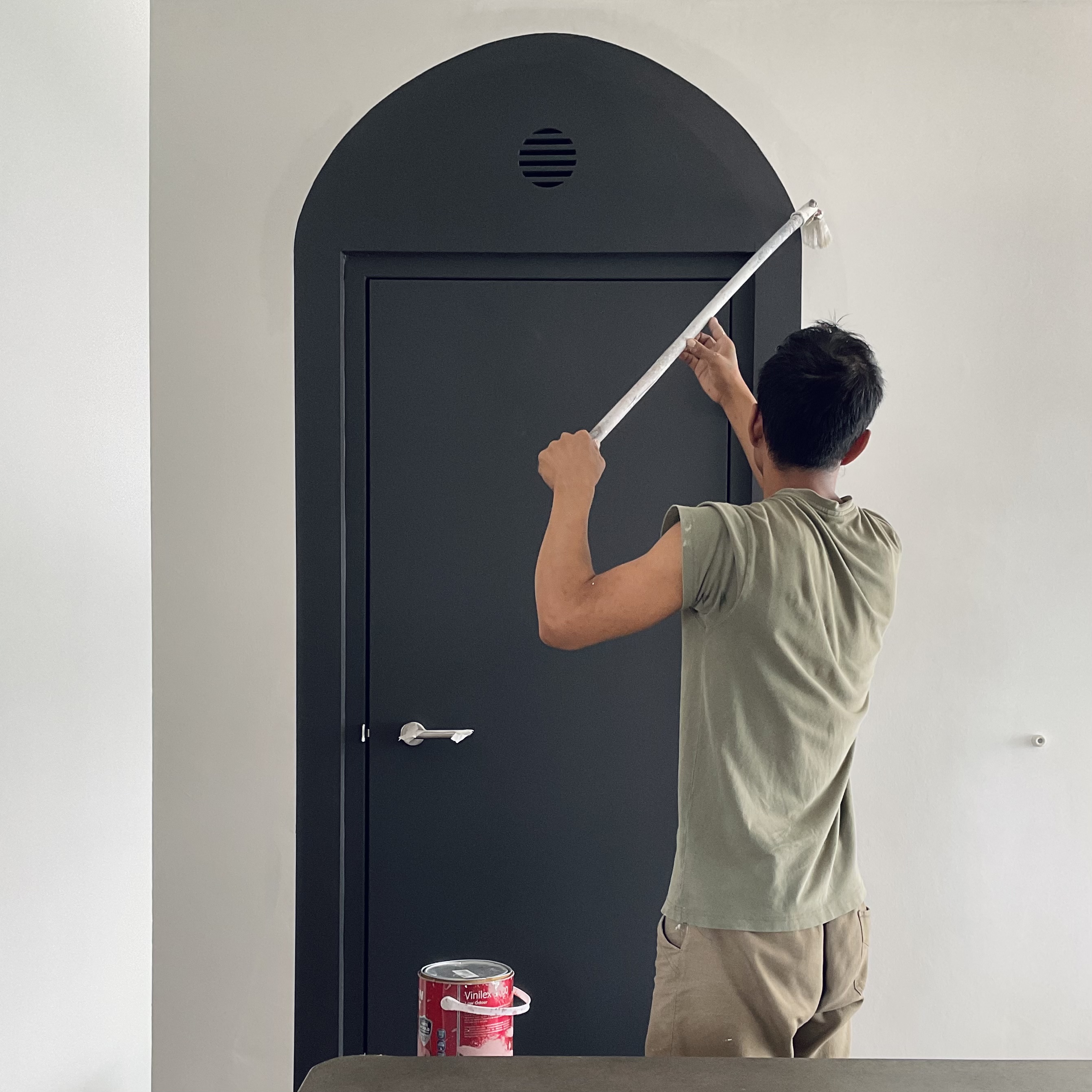 Entryway - cheap way to hide the ugly bomb shelter door! - black door, man painting, wall, ceiling, arch, ventilation