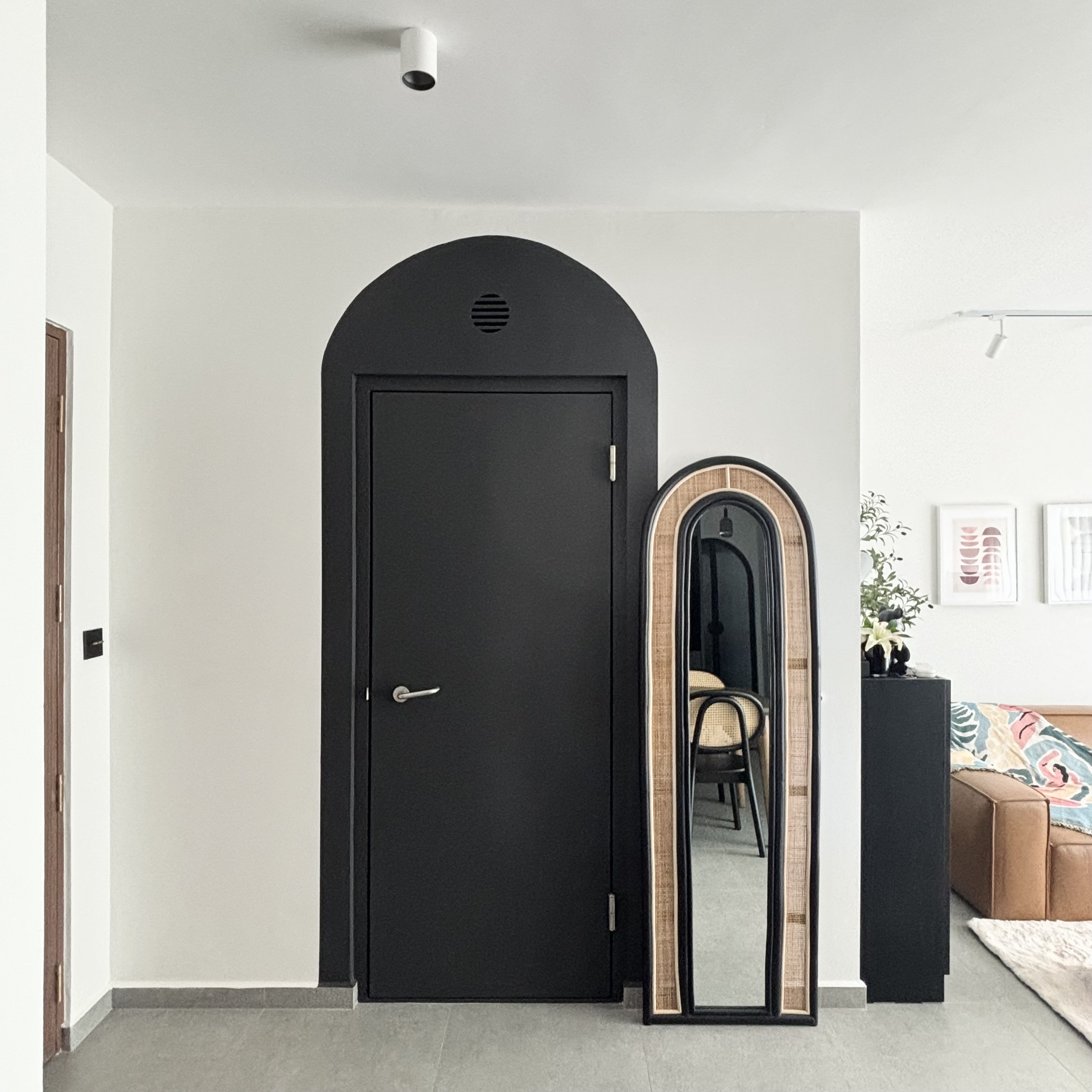 Entryway - cheap way to hide the ugly bomb shelter door! - Modern minimalist interior, black arched door, sleek door handle