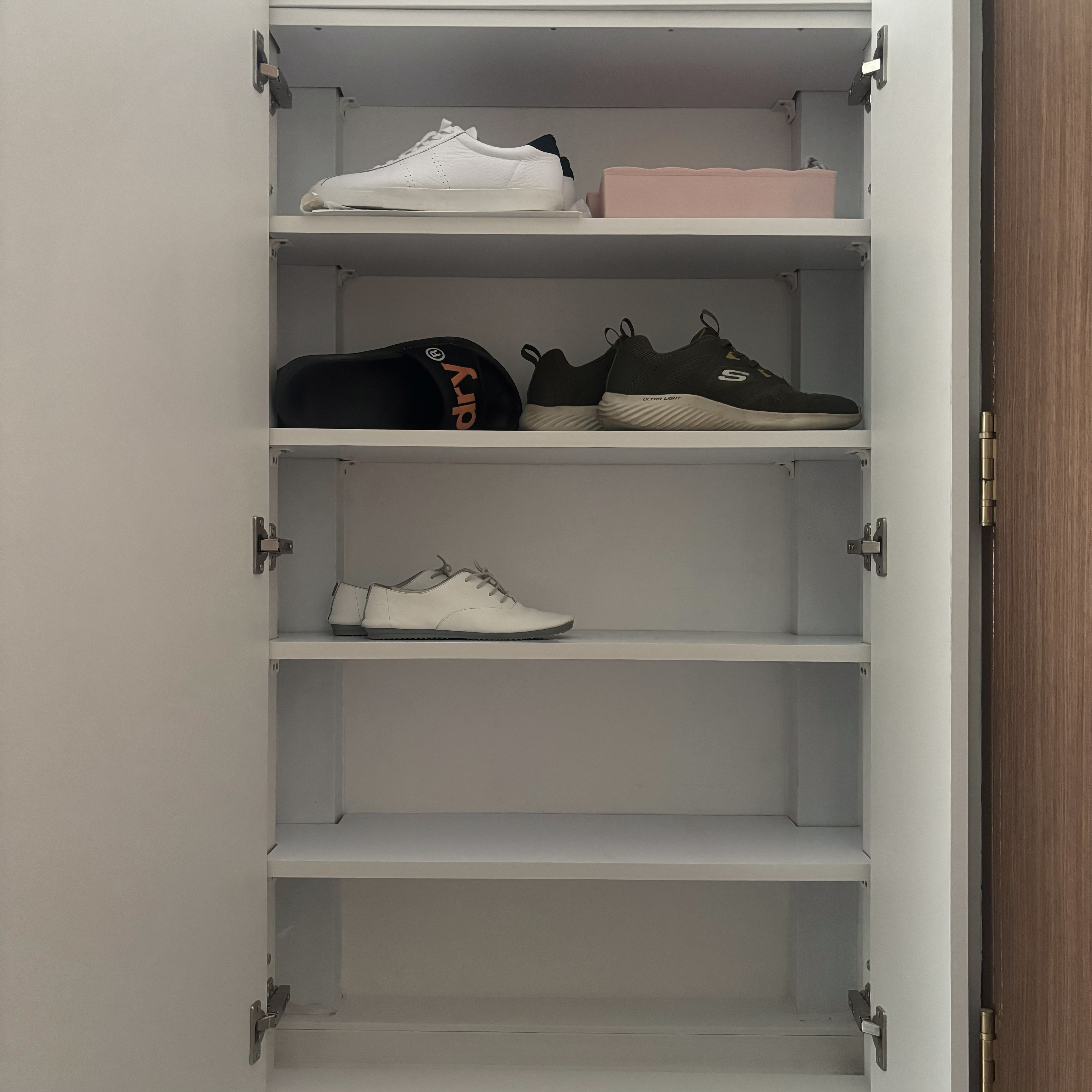 Entryway - cheap way to hide the ugly bomb shelter door! - Shoe organizer, neatly organized shoes, white sneakers, black cap