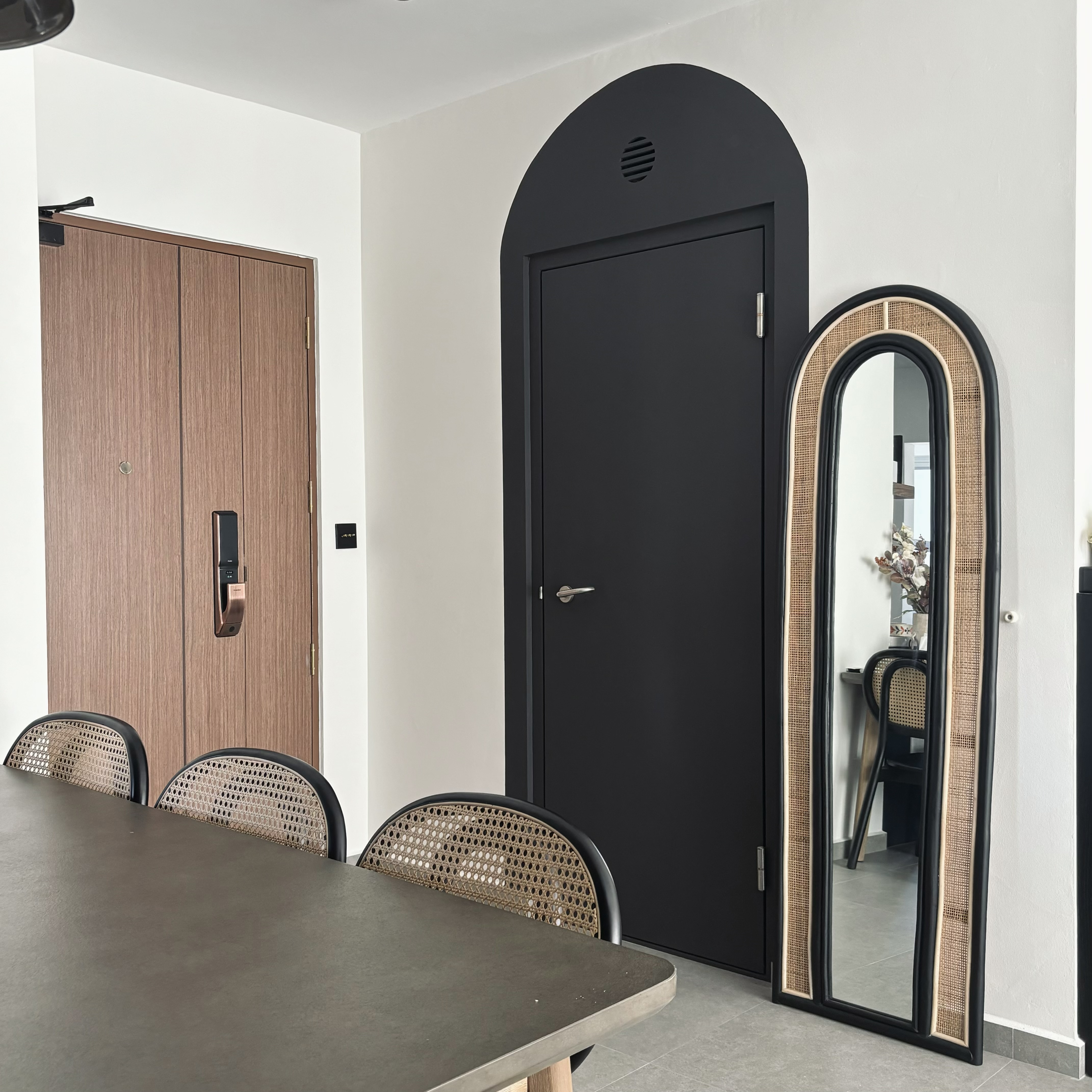Entryway - cheap way to hide the ugly bomb shelter door! - Wooden door, black door, arched doorway, modern furniture, dining