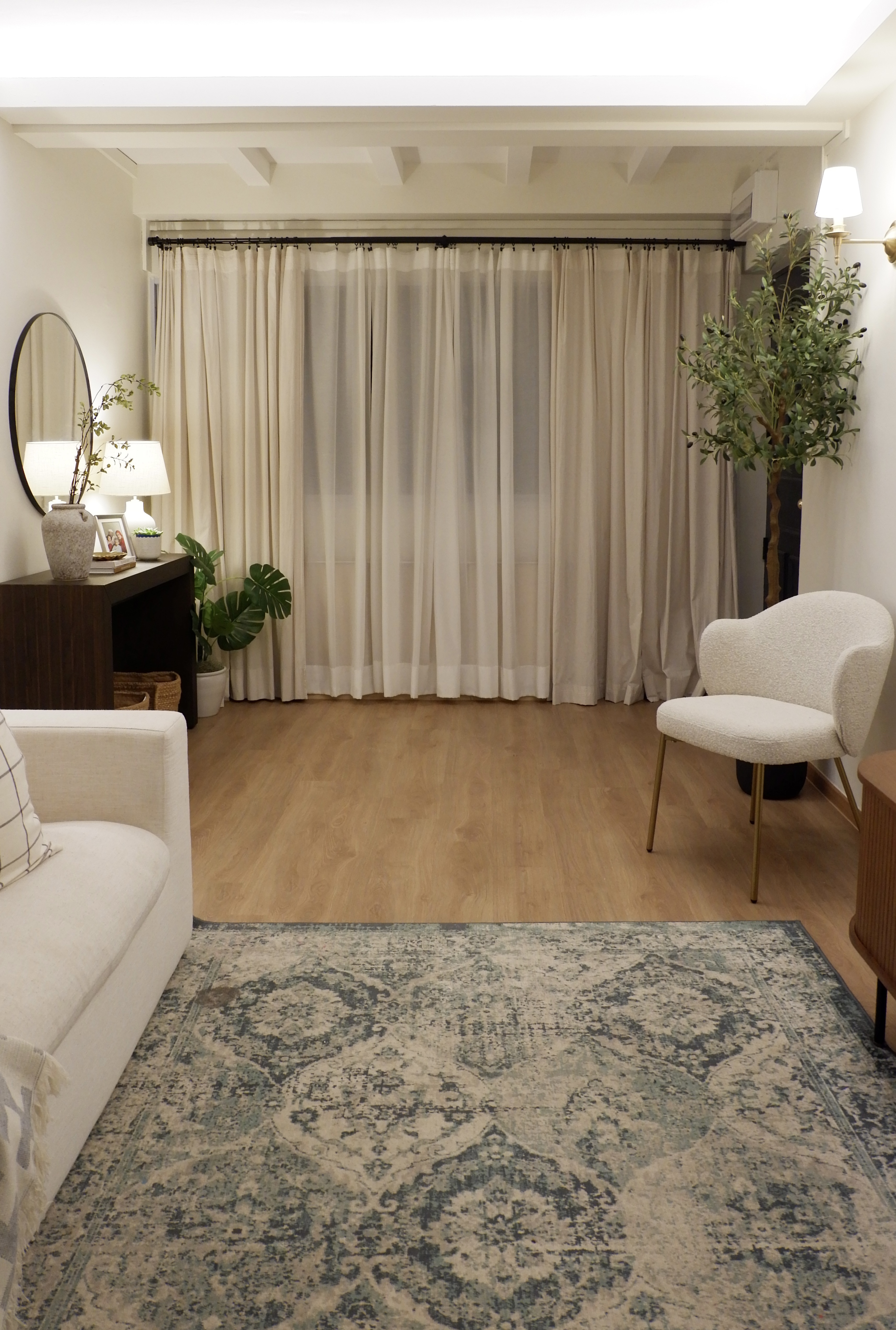 Styling Our Entryway for a Warm Welcome - Modern living room with beige curtains, wooden floor, cozy seating area