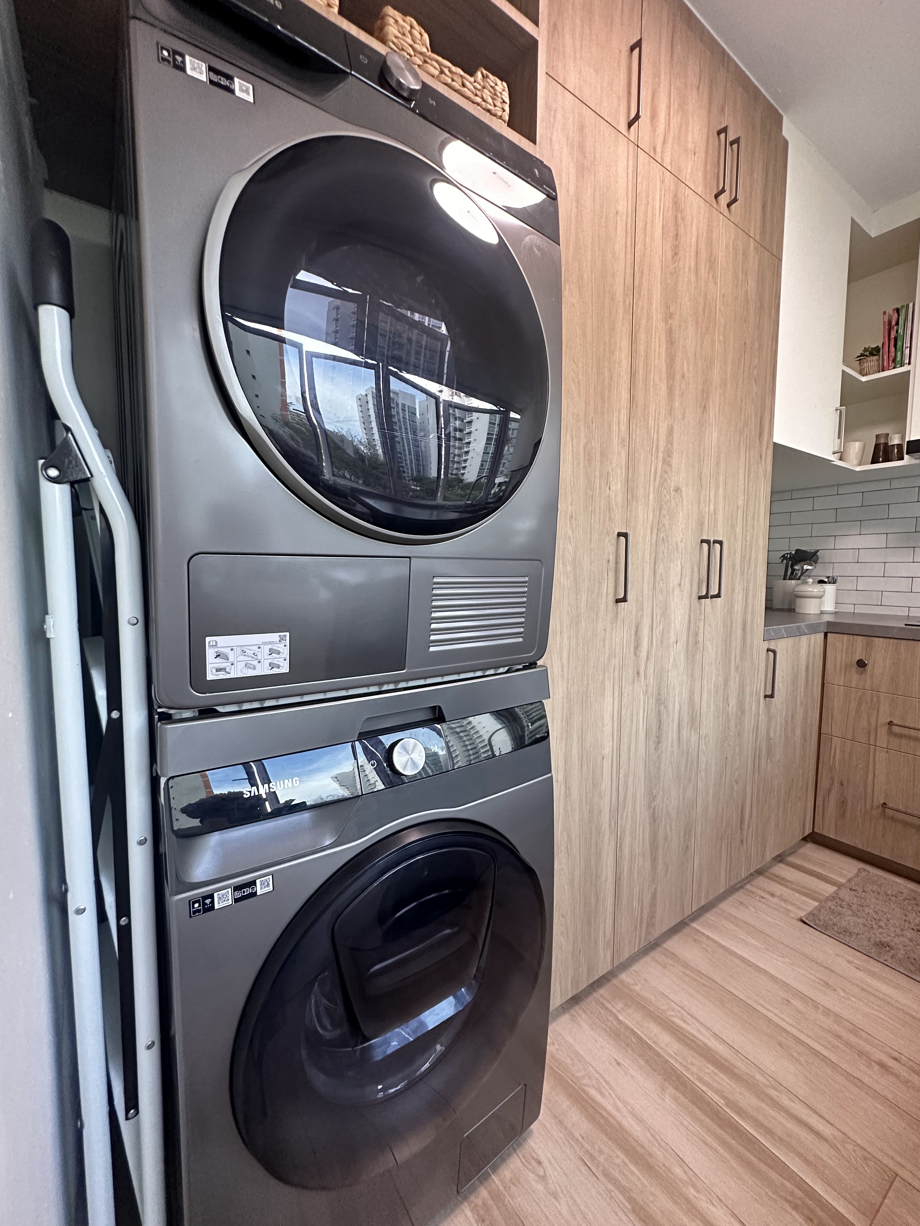 Laundry Bliss: Efficiency in Every Spin - Modern kitchen with built-in washer and dryer, sleek design, large window, wooden