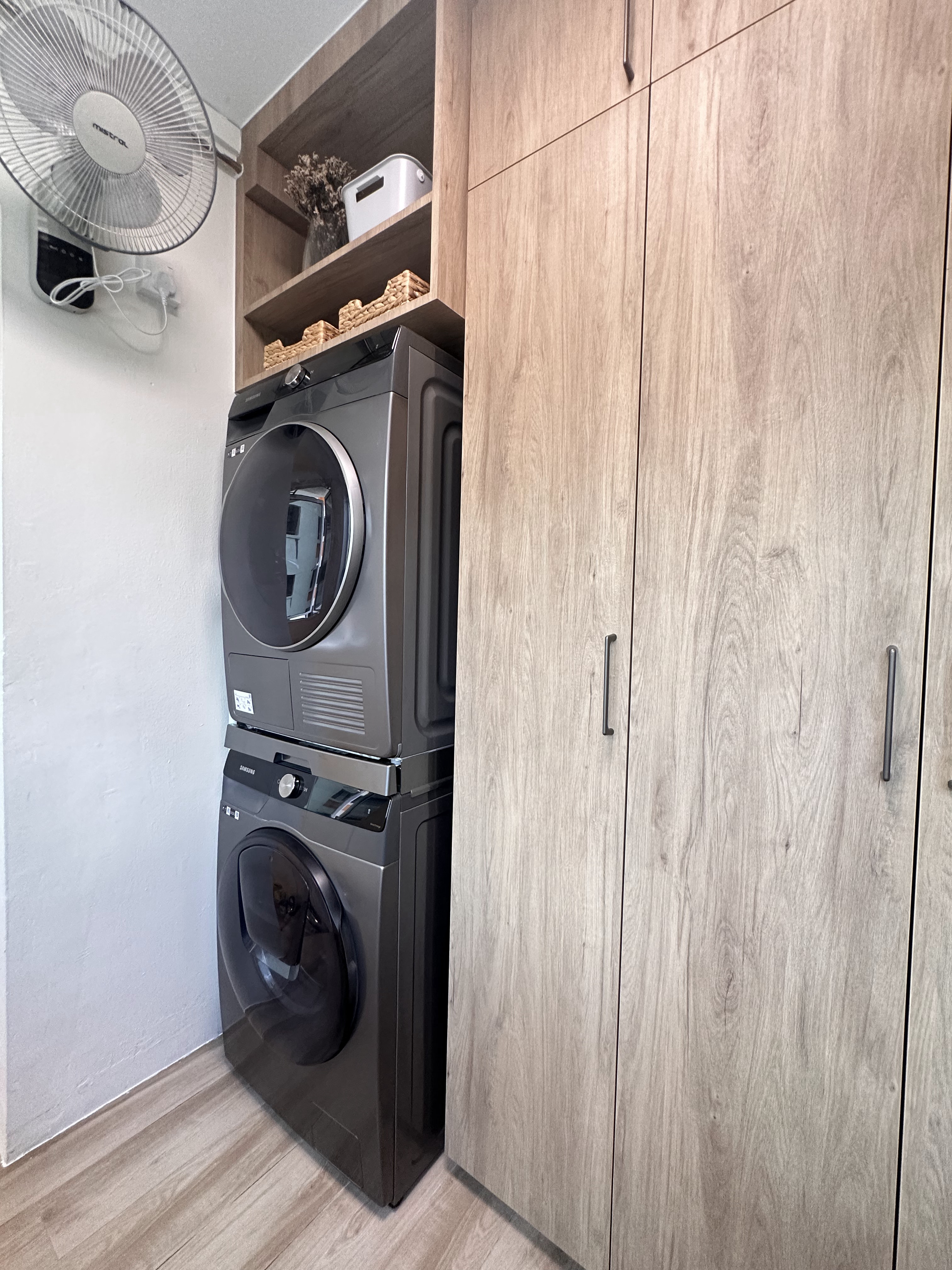 Laundry Bliss: Efficiency in Every Spin - Washing machine and dryer stacked side by side, modern design, built-in cabinetry