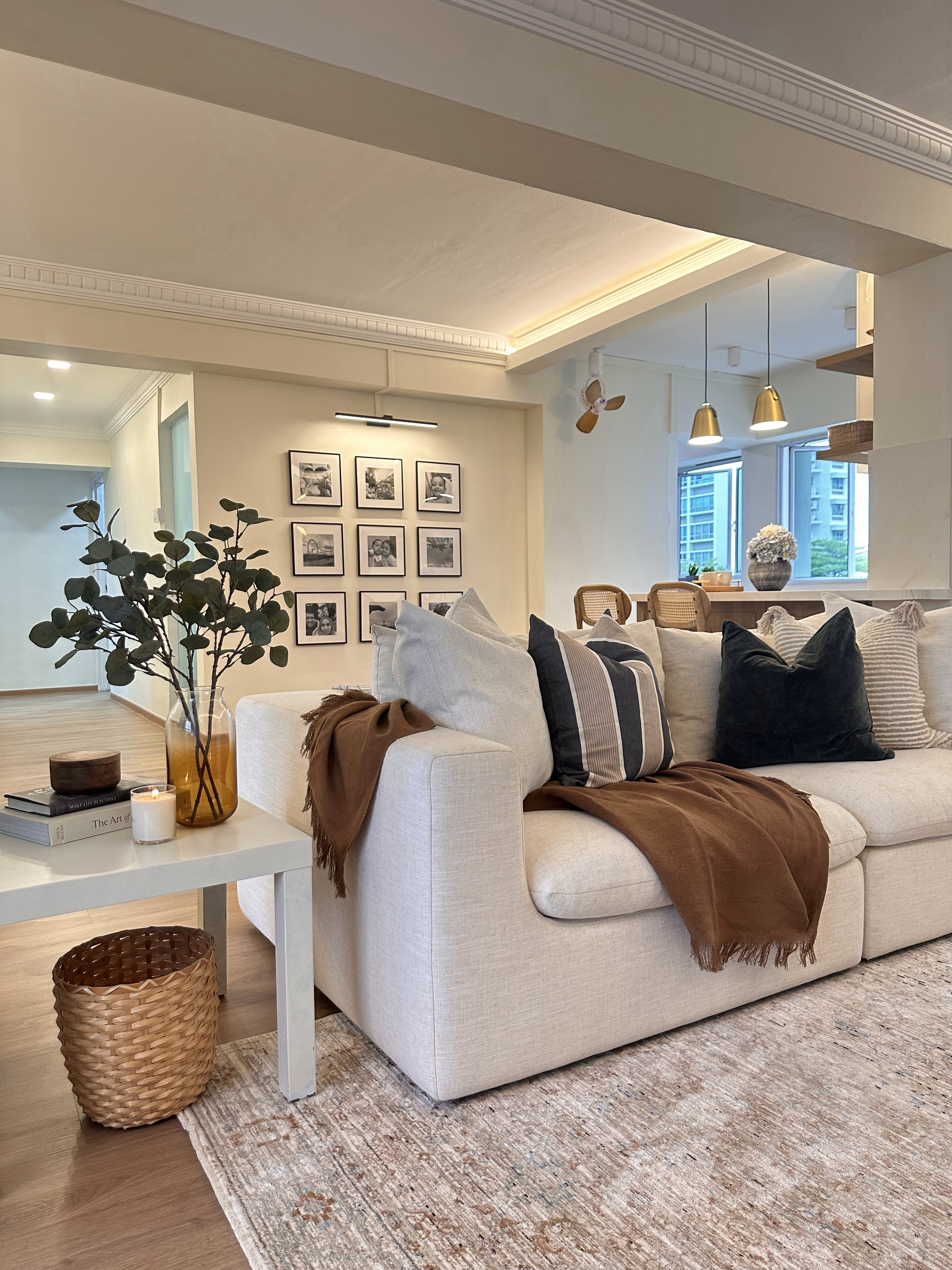 Every Corner Holds Precious Moments - modern living room, cozy seating, beige sofa, striped pillows, wooden coffee table