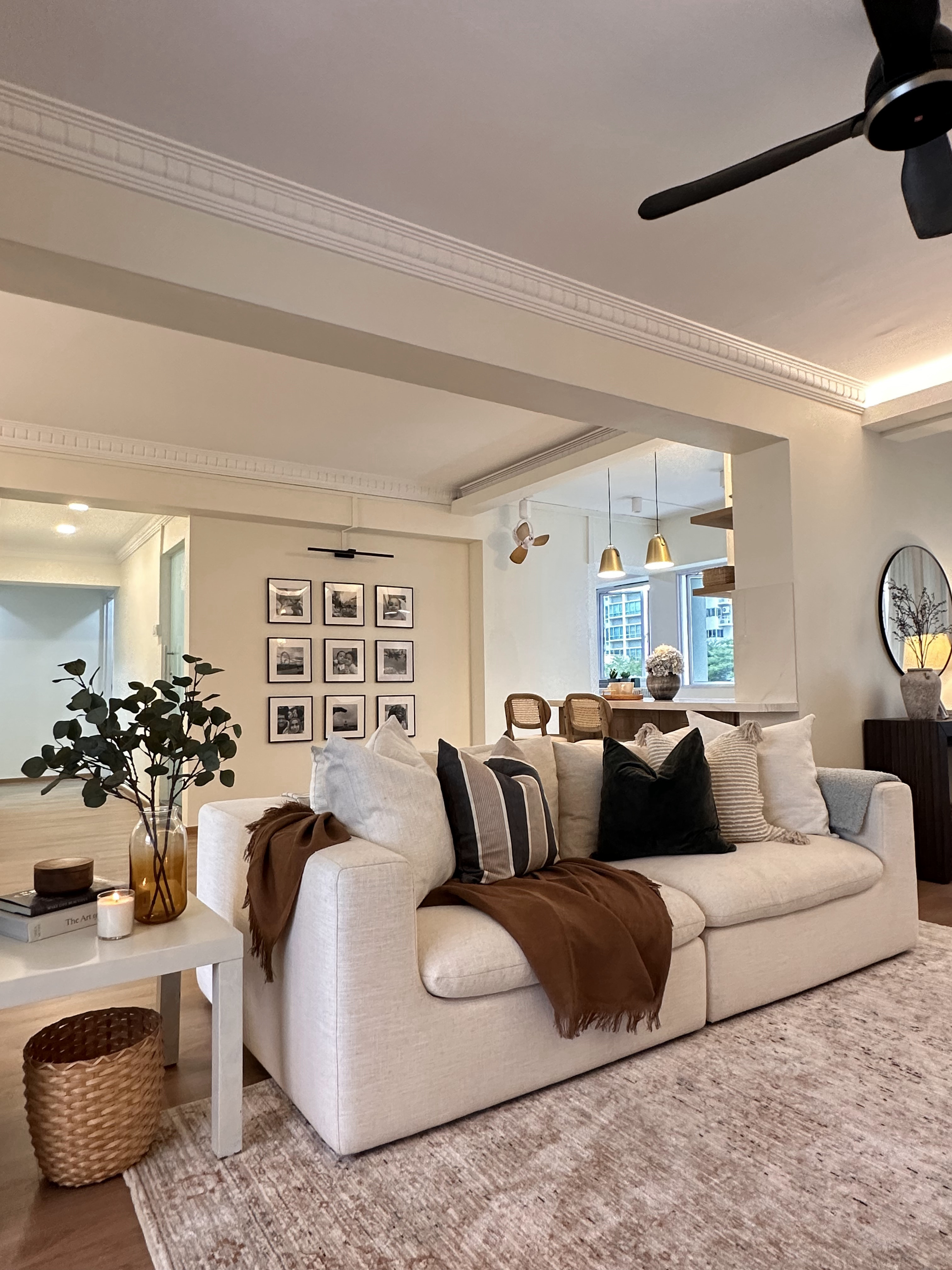 Every Corner Holds Precious Moments - Modern living room, cozy seating, beige sofa, decorative pillows, brown throw blanket