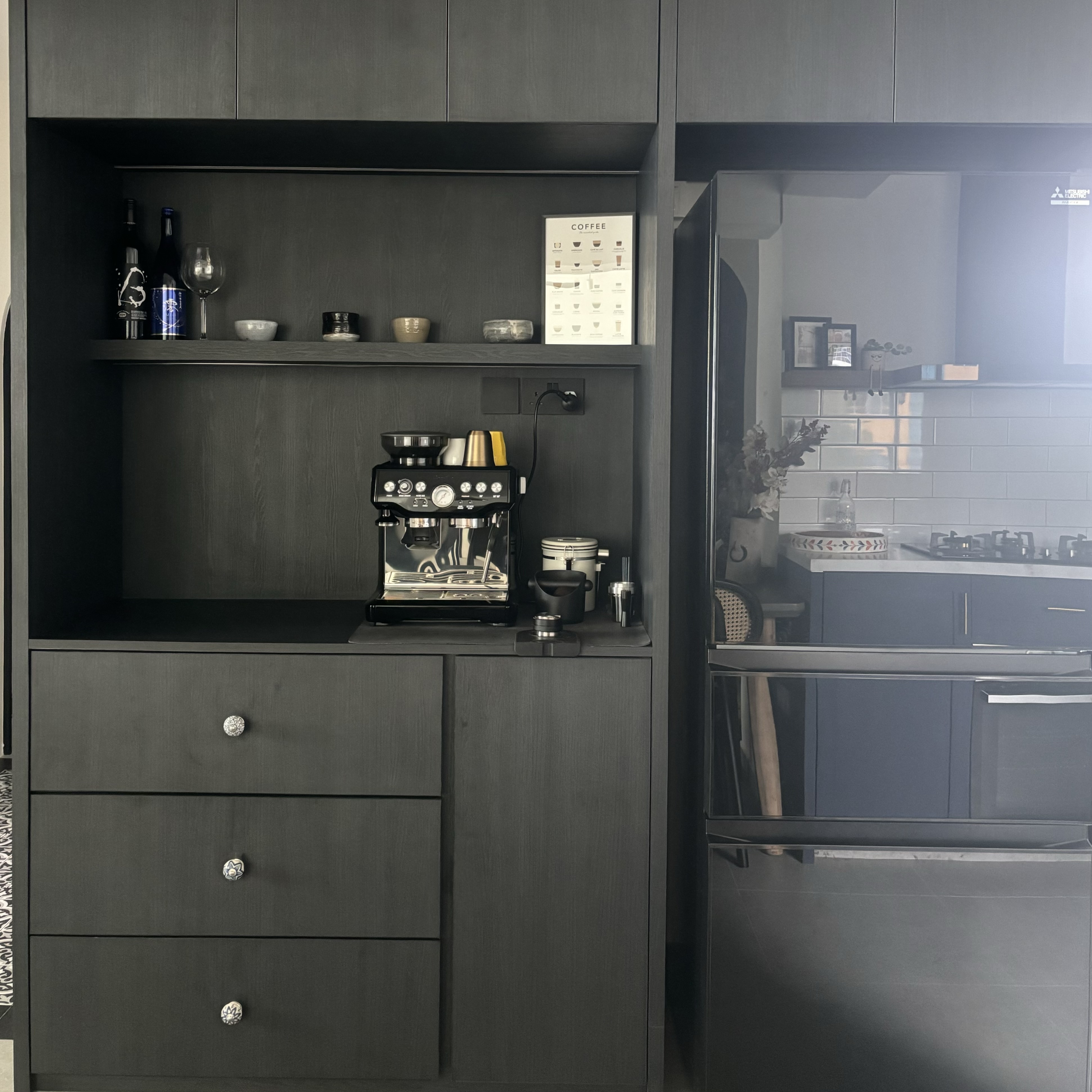 How to create a coffee nook in your home? - Dark gray kitchen cabinetry, minimalist design, black espresso machine, wine