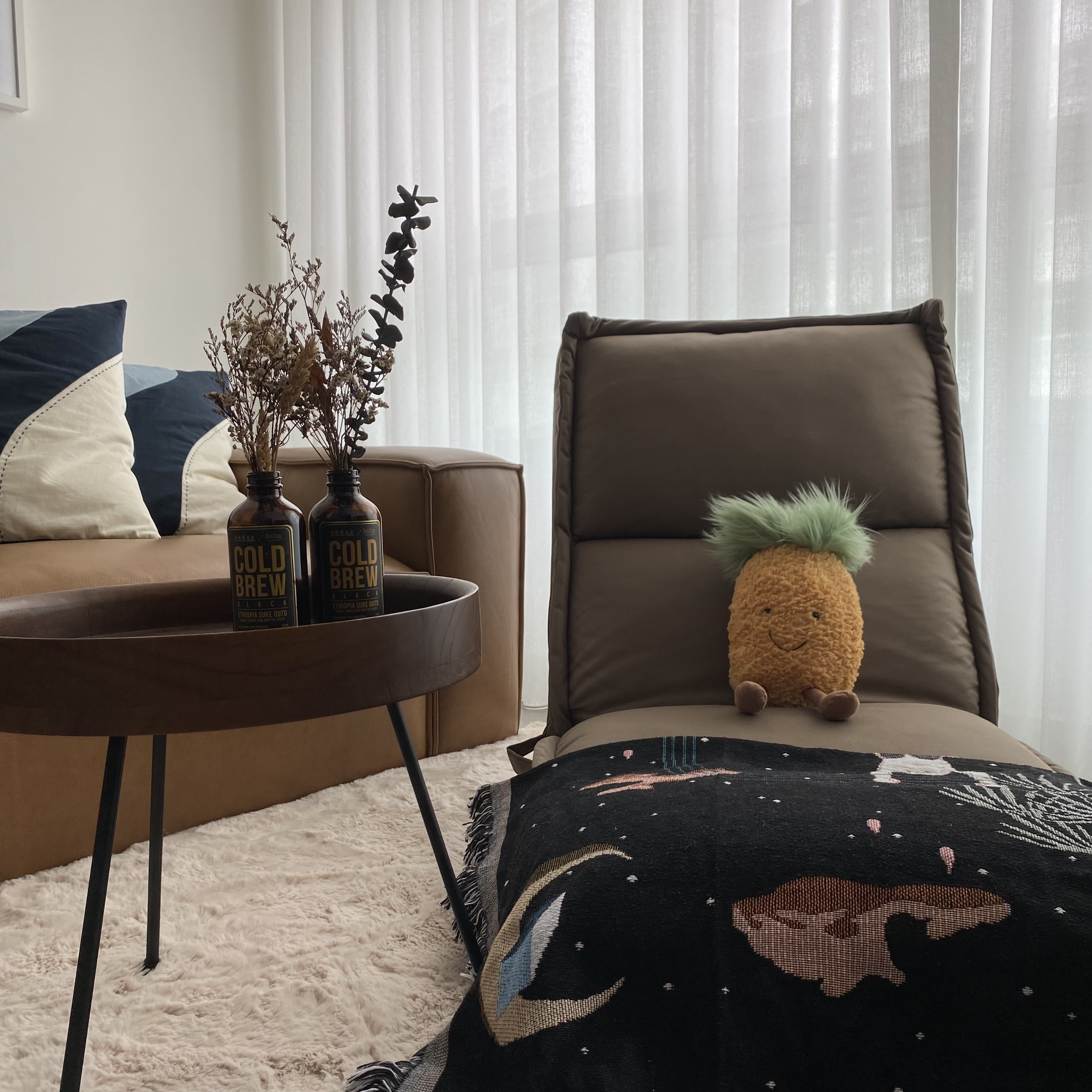 Creating comfortable nooks all around the house! - Couch, pillows, vase, plants, cozy, modern, minimalist, soft lighting