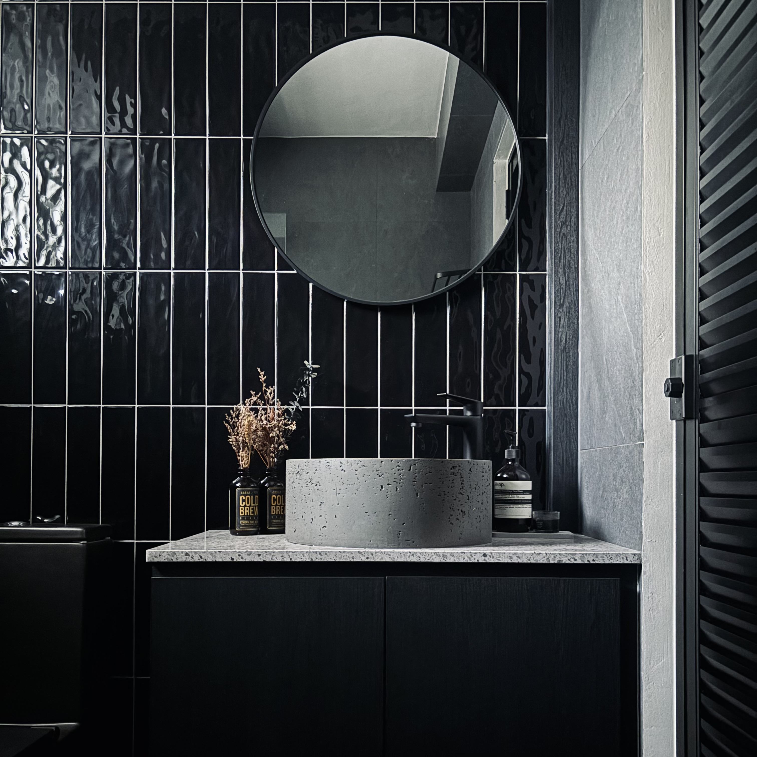 Creating comfortable nooks all around the house! - Black and white tiled bathroom vanity, modern design, sleek sink, round